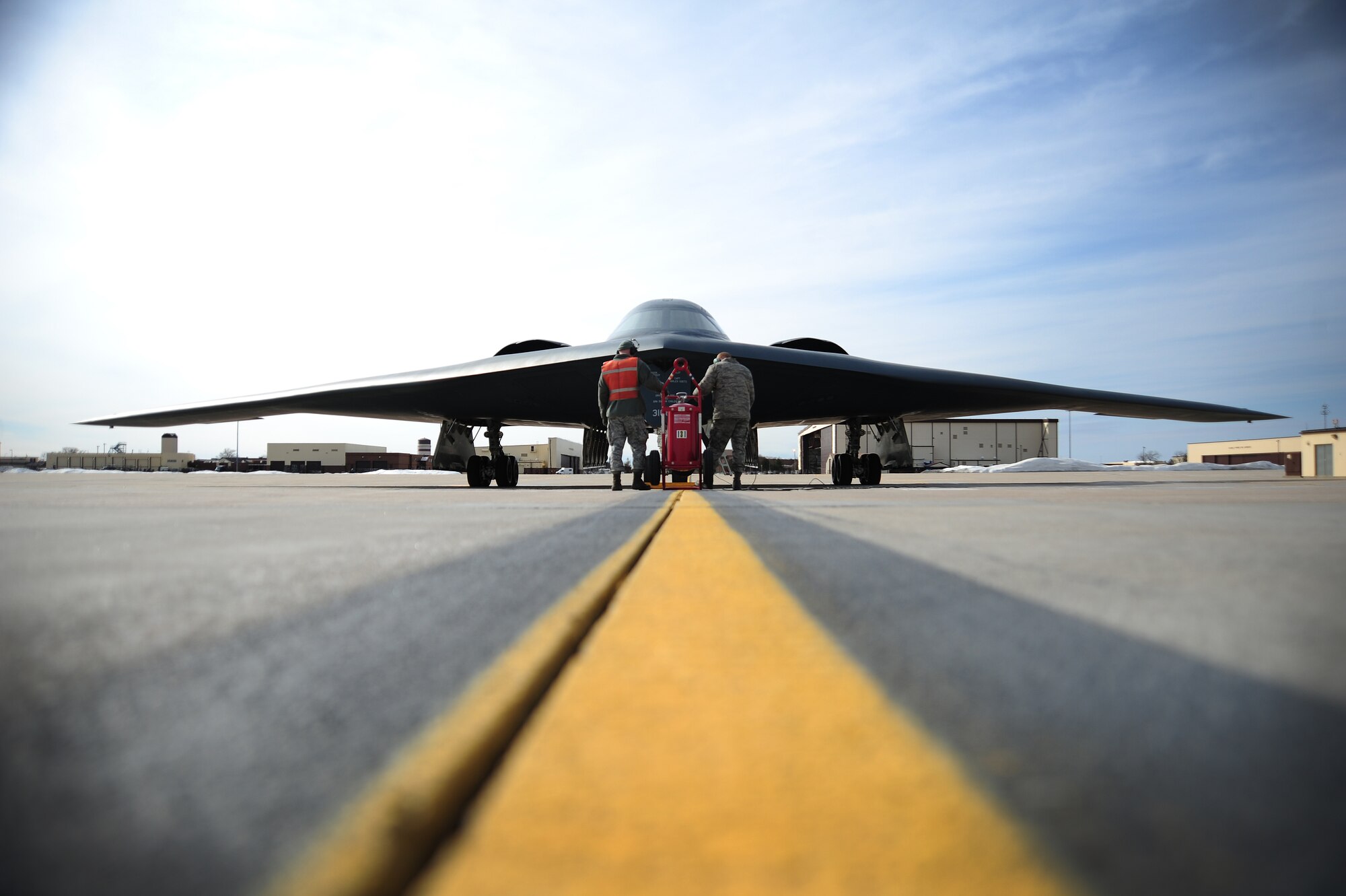 Senior Airman Joshua Thompson and Airman 1st Class James Fulton, both 509th Aircraft Maintenance Squadron crew chiefs, use communication cords to speak to pilots while performing pre-flight checks at Whiteman Air Force Base, Mo., Feb. 24, 2014. As technical experts on the B-2 Spirit, crew chiefs work directly with the aircraft, ensuring pilots have the most reliable, mission-capable aircraft possible to complete the mission. (U.S. Air Force photo by Staff Sgt. Nick Wilson/Released)