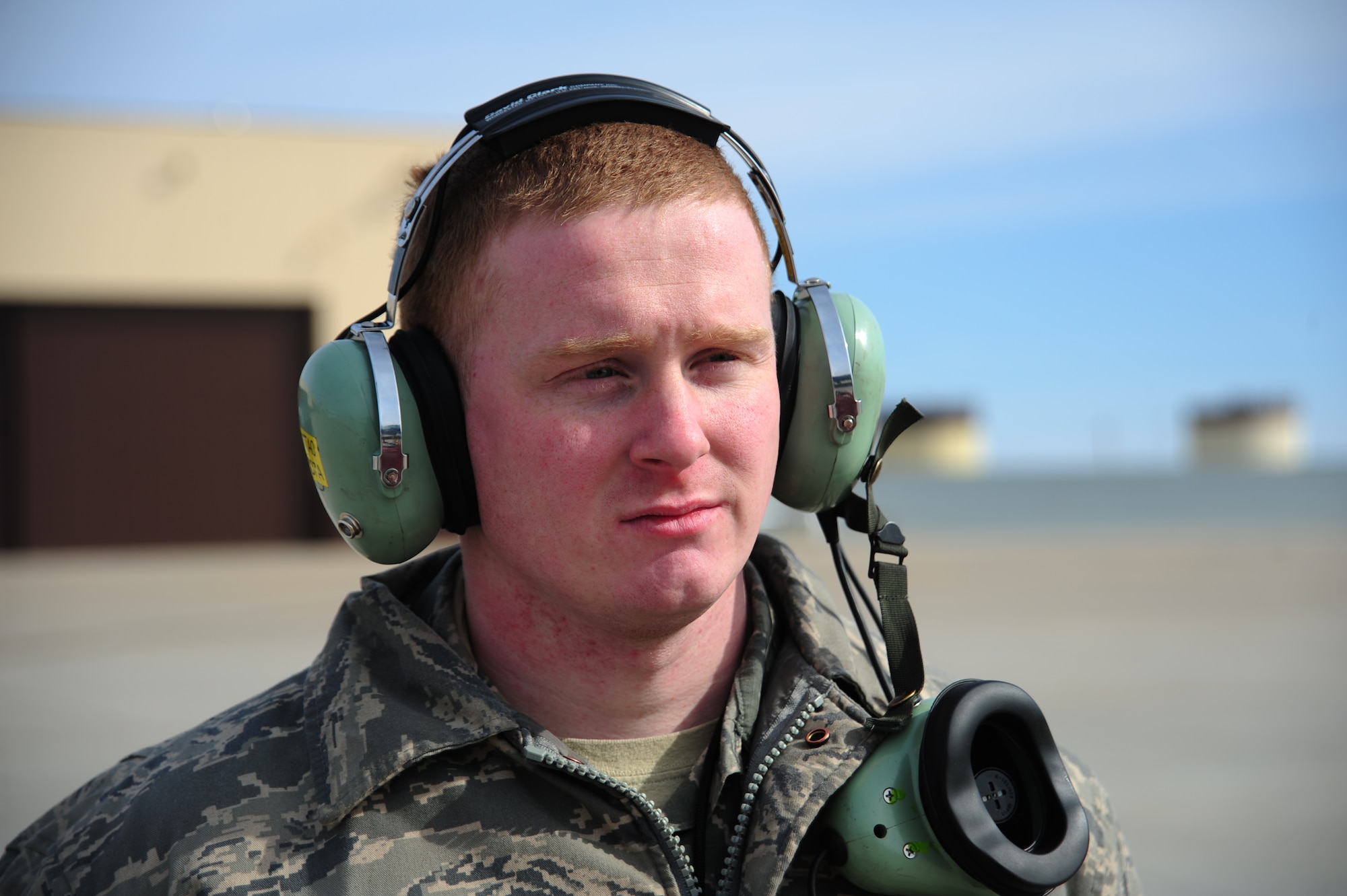 Airman 1st Class James Fulton, 509th Aircraft Maintenance Squadron crew chief, listens to instructions from a B-2 Spirit pilot during a pre-flight check at Whiteman Air Force Base, Mo., Feb. 24, 2014. The communications cord allows pilots and ground crew to communicate during pre-flight. (U.S. Air Force photo by Staff Sgt. Nick Wilson/Released)