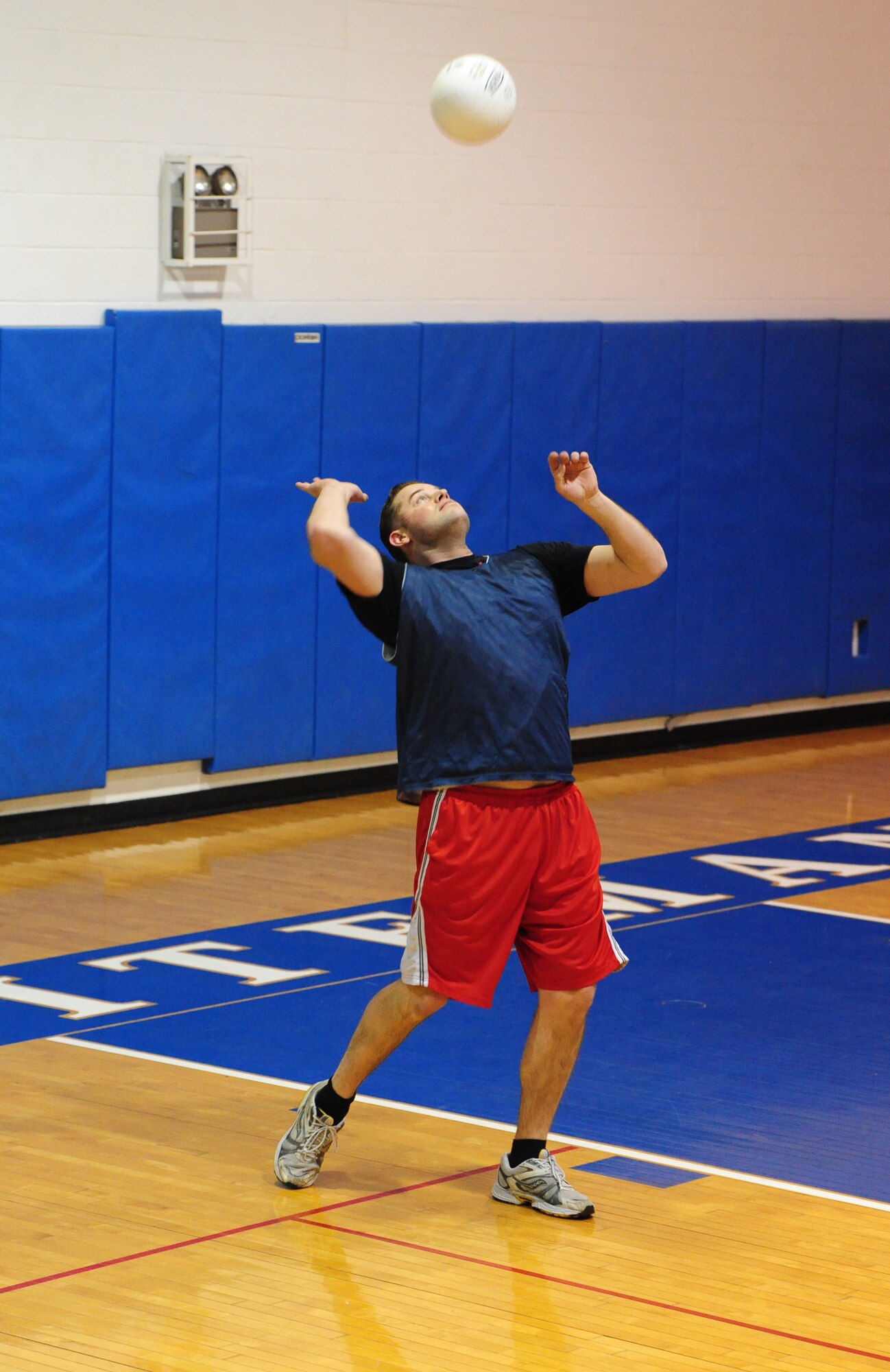 Asa McCurdy, 709th Munitions Support Squadron intramural volleyball team member, serves the ball during the first half of a volleyball game against the 509th Force Support Squadron at the Fitness Center of Whiteman Air Force Base, Mo., Feb. 18, 2014. The 509th FSS defeated the 709th MUNS during game one with a score of 25 to 20. (U.S. Air Force photo by Staff Sgt. Nick Wilson)