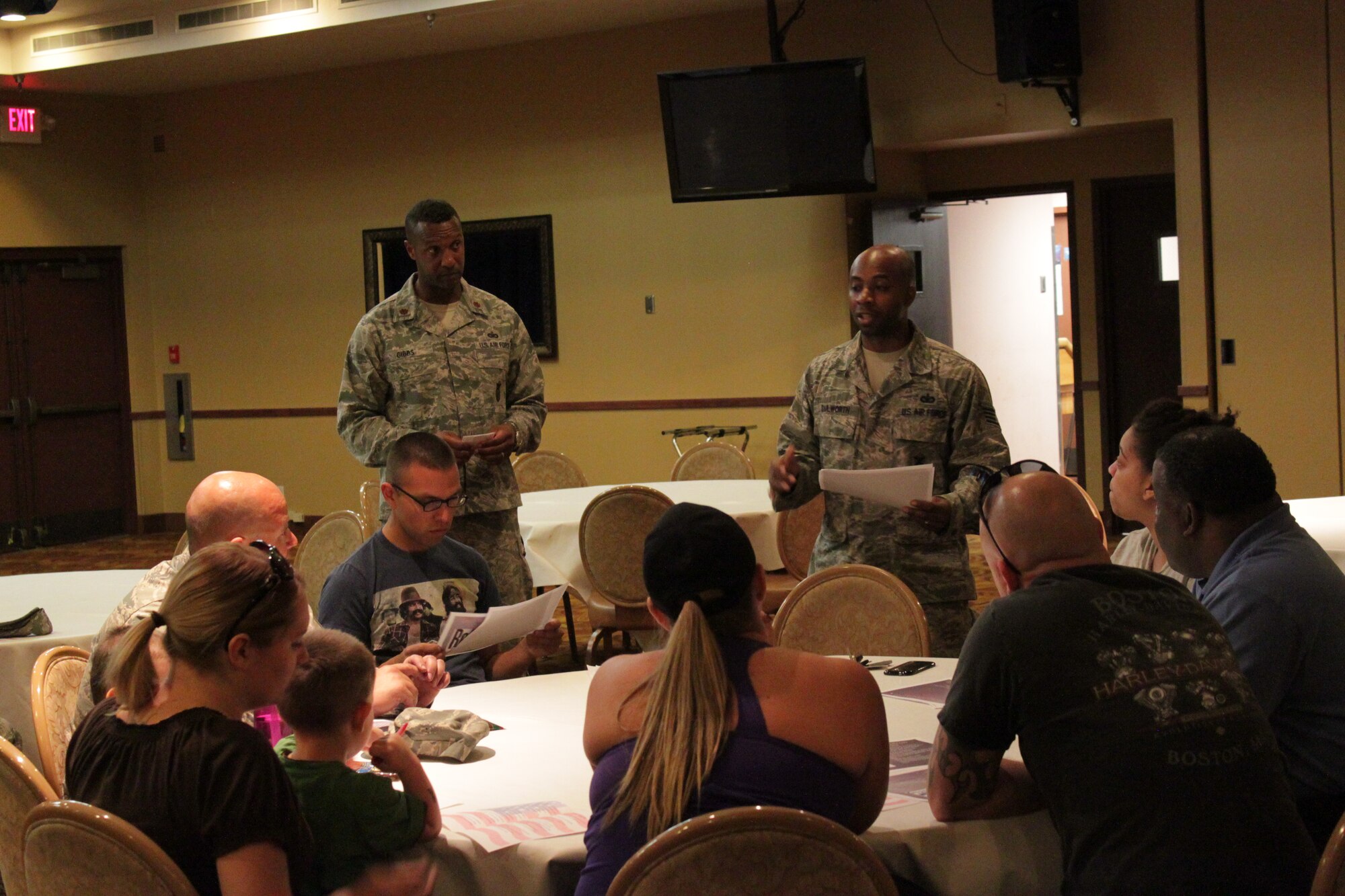 Maj. Sean Gibbs, 56th Security Forces Squadron commander, hands the meeting over to Staff Sgt. Travis Dulworth, 56th SFS police operations NCO in charge. Dulworth explained how to help prevent crime in neighborhoods. (U.S. Air Force photo/Jayson Burns)