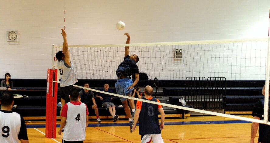 J. B.  Arce, 509th Force Support Squadron intramural volleyball team member, defends against Desmond Reaves, 709th Munitions Support Squadron, during the first half of a volleyball game against the 709th Munitions Support Squadron at the Fitness Center of Whiteman Air Force Base, Mo., Feb. 18, 2014. The 509th FSS defeated the 709th MUNS during game one with a score of 25 to 14. (U.S. Air Force photo by Staff Sgt. Nick Wilson)