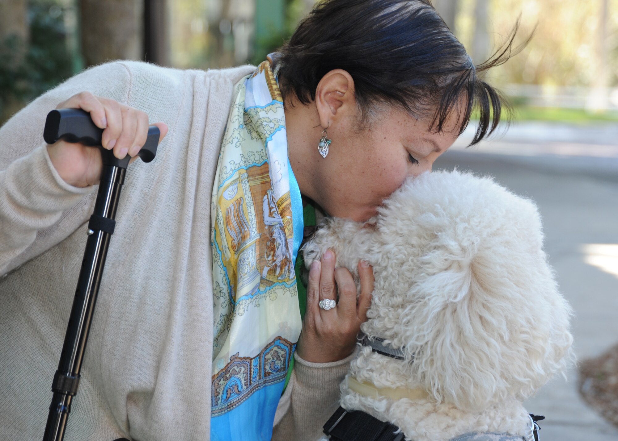 Retired Capt. Mary McGriff kisses Courage, her service dog, during an Air Force Reserve Command Yellow Ribbon Program training event at which she spoke Jan. 25, 2014, in Hilton Head Island, S.C. McGriff was diagnosed with post-traumatic stress disorder following a 2003-2004 deployment to Iraq and cites Courage’s presence with helping her overcome flashbacks and panic attacks. (U.S. Air Force photo by Peter R. Miller)