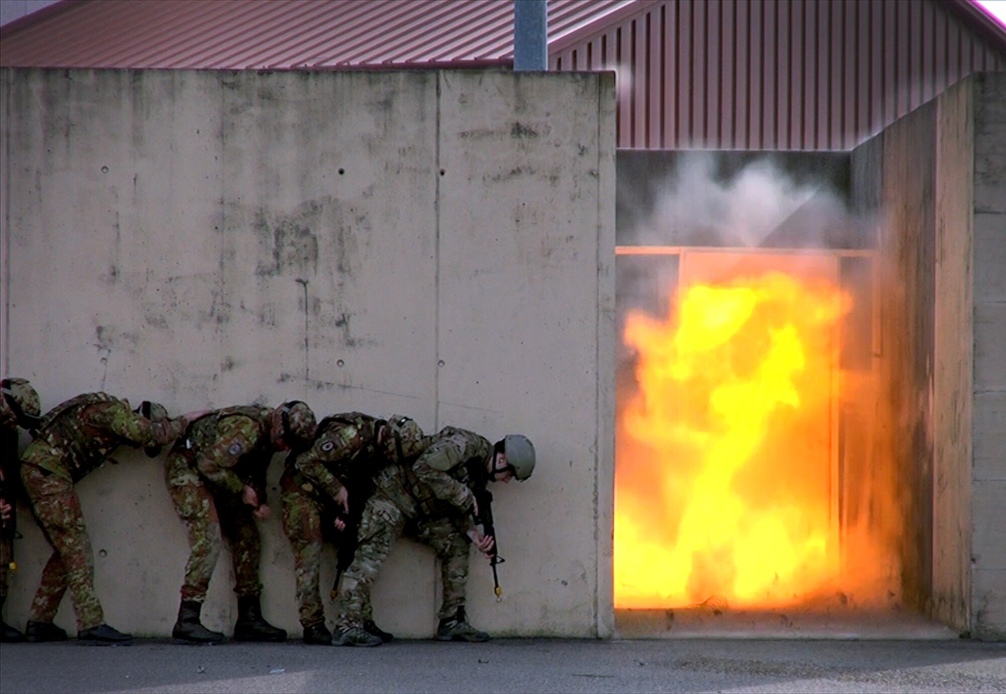 A team of Italian army soldiers and 31st Civil Engineer Squadron explosive ordnance disposal technicians practice dynamic entry tactics Feb. 27, 2014, at Aviano Air Base, Italy, during a two-day training event. Throughout the training, the coalition partners shared their EOD knowledge and experience with one another. (U.S. Air Force photo/Senior Airman Kristi MacDonald)