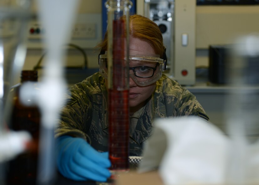 U.S. Air Force Senior Airman Miranda Wolverton, 100th Logistics Readiness Squadron Fuels laboratory technician from Parsons, Kan., measures a fuel sample Feb. 11, 2014, on RAF Mildenhall, England. Technicians must mix exact amounts of fuel and water to test the Fuels System Icing Inhibitor. Performing the FSII test confirms the fuel won’t freeze when aircraft reach high altitudes. (U.S. Air Force photo by Airman 1st Class Preston Webb/Released)