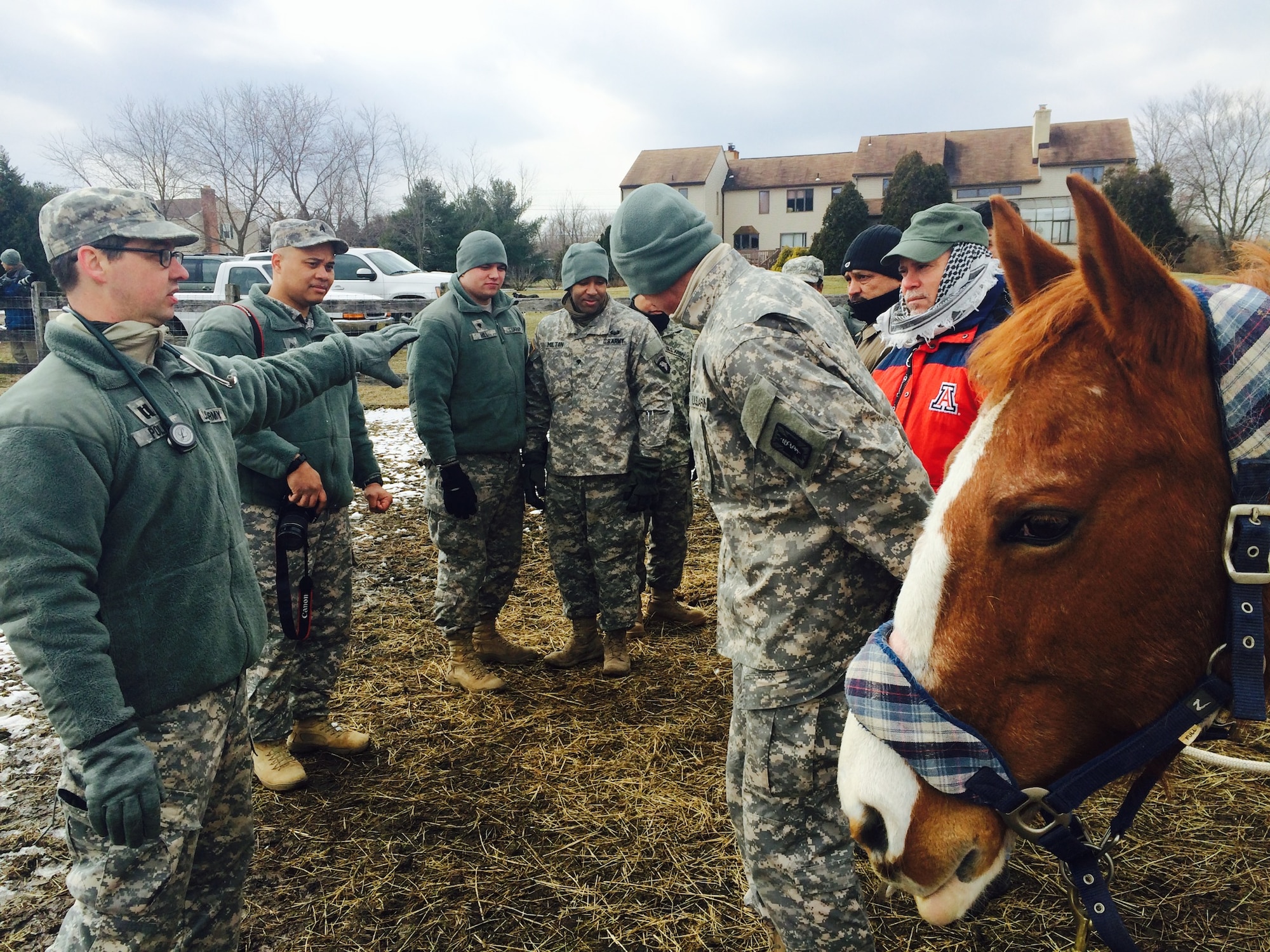 Soldiers from the 424th Multi-functional Medical Battalion and 422nd Medical Detachment Veterinary Services receive instruction from Capt. John Polk (left), 422nd MDVS company commander and veterinarian, as they prepare for a lesson in basic horse-handling Feb. 27, 2014, at Forgotten Angels Equine Rescue in Medford, N.J. In addition to the hands-on training, Soldiers offered health exams and donated vaccines and deworming medicine during ‘Operation Mr. Ed’, a training scenario that was part of the 78th Training Division’s Combat Support Training Exercise. The equine sanctuary was used to simulate a ranch in a simulated deployed location and allowed Soldiers to practice handling large livestock. (U.S. Air Force Photo by 2nd Lt. Carrie Volpe/Released)