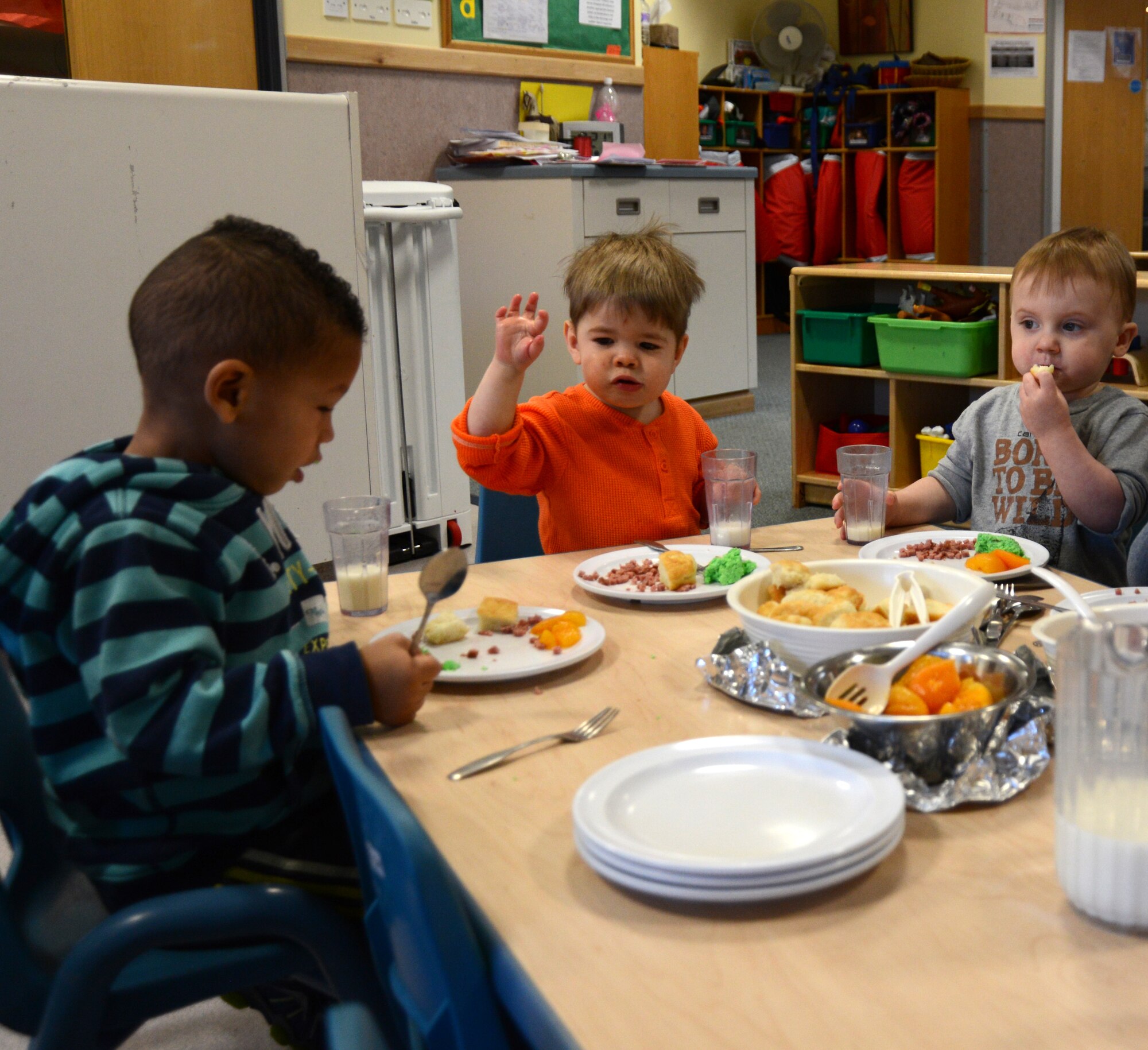 Children at the RAF Mildenhall Child Development Center eat green eggs and ham on National Read Across America Day March 3, 2014, on RAF Mildenhall, England. National Read Across America Day is an observance of Dr. Seuss’ birthday. Events for the day included a birthday cake for Dr. Seuss, green eggs and ham for breakfast and story time. (U.S. Air Force photo by Airman 1st Class Kelsey Waters/Released)