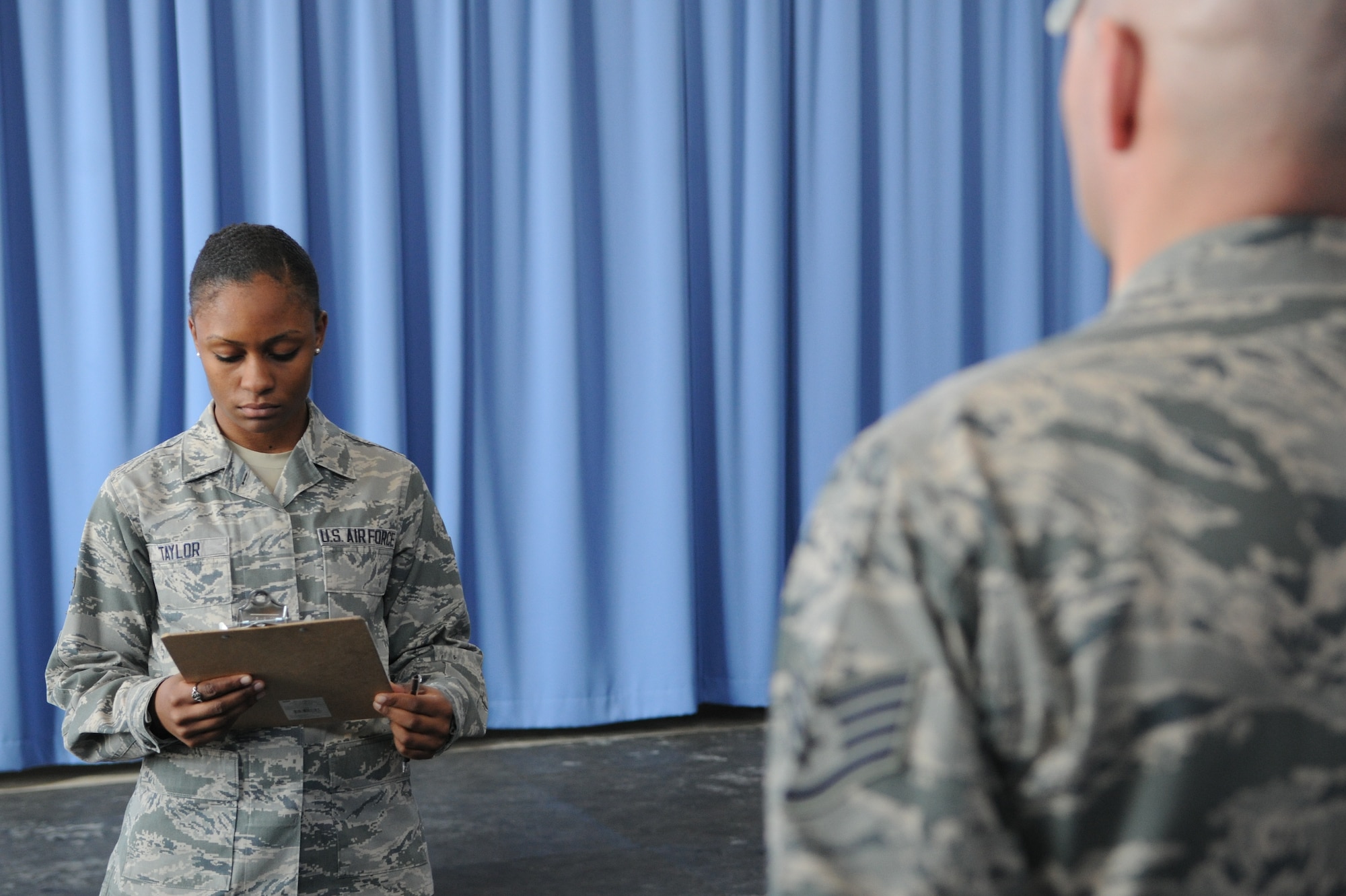Airman 1st Class Grace Taylor prepares to call the next movement for a staff sergeant’s evaluation on Joint Base Anacostia-Bolling, Washington, D.C., on March 4, 2014. Taylor, United States Air Force Honor Guard tech school instructor, will determine if his skills are proficient or needs to endure more training. (U.S. Air Force photo/Airman 1st Class Ryan J. Sonnier)