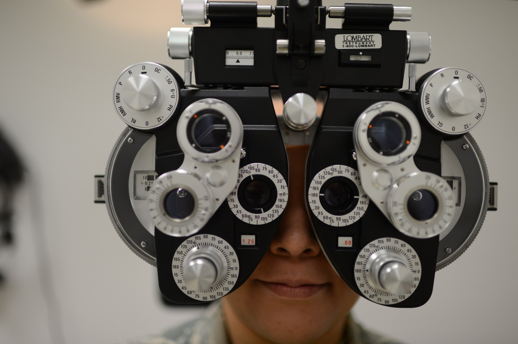 U.S. Air Force Senior Airman Ivonn Zepeda Chavez, 52nd Aerospace Medicine Squadron optometry technician from Wichita, Kan., looks through a phoropter at Spangdahlem Air Base, Germany, March 5, 2014. Optometry technicians use equipment like the phoropter to determine a patient’s prescription. (U.S. Air Force photo by Senior Airman Gustavo Castillo/Released)