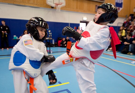 Parker Palik, son of Staff Sgt. Noah Polcar, 37th Airlift Squadron loadmaster, launches a kick during a match during the 2014 U.S. Air Forces in Europe and Air Forces Africa martial arts tournament March 1, 2014, Ramstein Air Base, Germany. The 2014 USAFE-AFFRICA martial arts tournament promotes good sportsmanship, healthy competition, and a way for children and teenagers to stay active. (U.S. Air Force photo/Airman 1st Class Jordan Castelan)