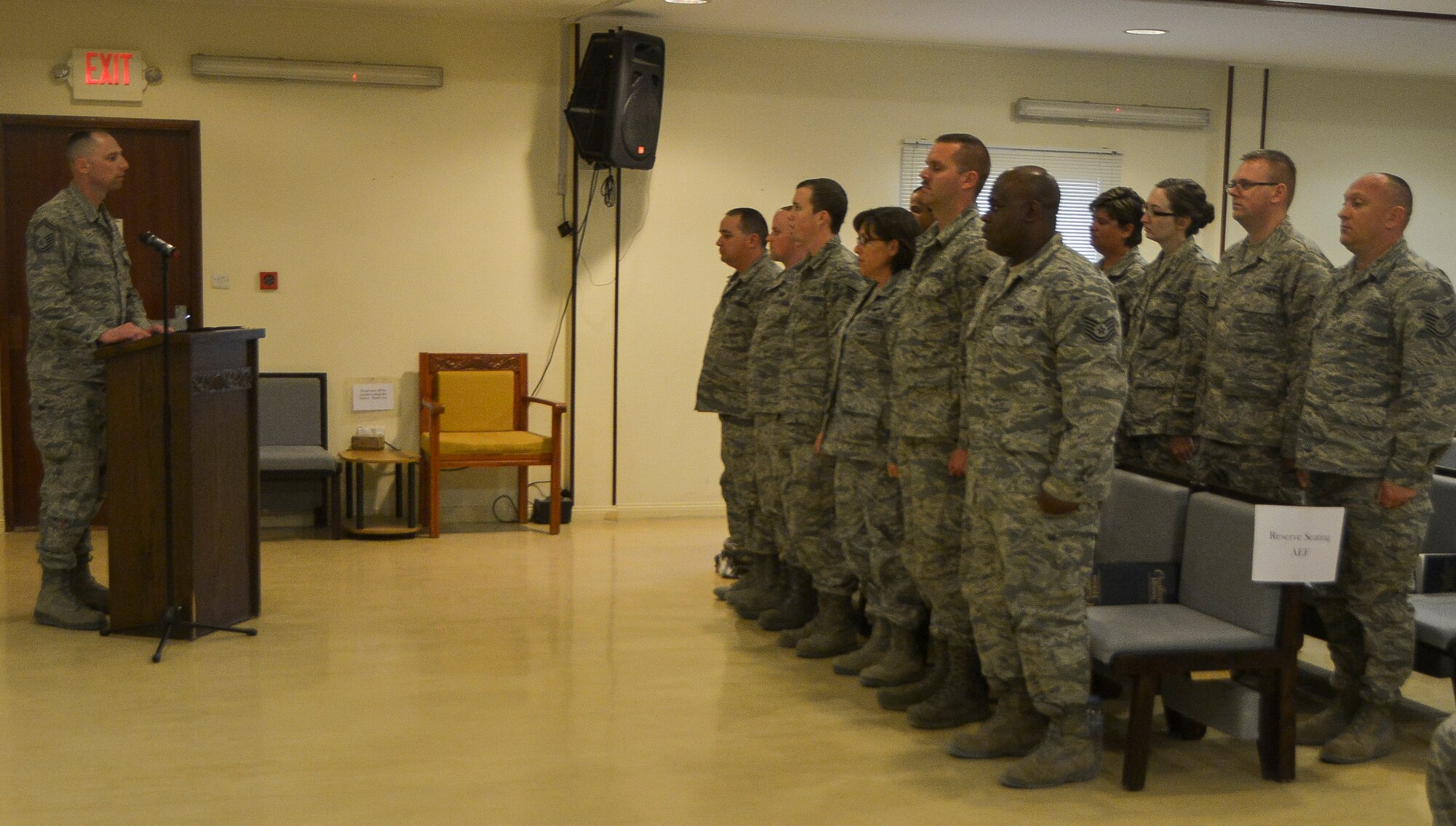 Airmen from Pease Air National Guard Base, N.H, stand during a roll call in rememberance of a fallen hero, Master Sgt. David Poirier, at Al Udeid Air Base, Qatar, Mar. 3, 2014. Poirier died on Feb. 28, 2014 in a non-combat-related incident while deployed supporting Operation Enduring Freedom. Porier was a member of the New Hampshire Air National Guard’s 157th Operations Support Squadron at Pease Air National Guard Base, N.H., and was a postmaster while not on duty. Poirier served in the military for more than 22 years. (U.S. Air Force photo/Senior Airman Jared Trimarchi) 