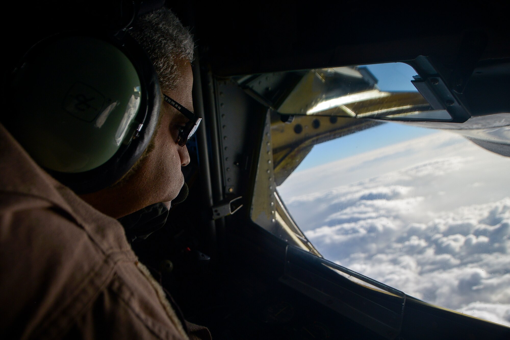 Master Sgt. Jorge Brewer, a 340th Expeditionary Air Refueling Squadron boom operator, looks out the back of a KC-135 Stratotanker before an aerial refueling mission at an undisclosed location in Southwest Asia, Feb. 26, 2014. Airmen from the 340th EARS at Al Udeid Air Base, Qatar, make up the U.S. Air Forces Central Command’s area of responsibility main refueling squadron which supports the aircraft of Operation Enduring Freedom. Aerial refueling extends the capabilities of any aircraft by expanding the range, limited only by crew fatigue and fuel consumption of the aircraft. Brewer hails from Raleigh, N.C. and is deployed from Seymour Johnson Air Force Base, N.C. (U.S. Air Force photo/Senior Airman Jared Trimarchi) 