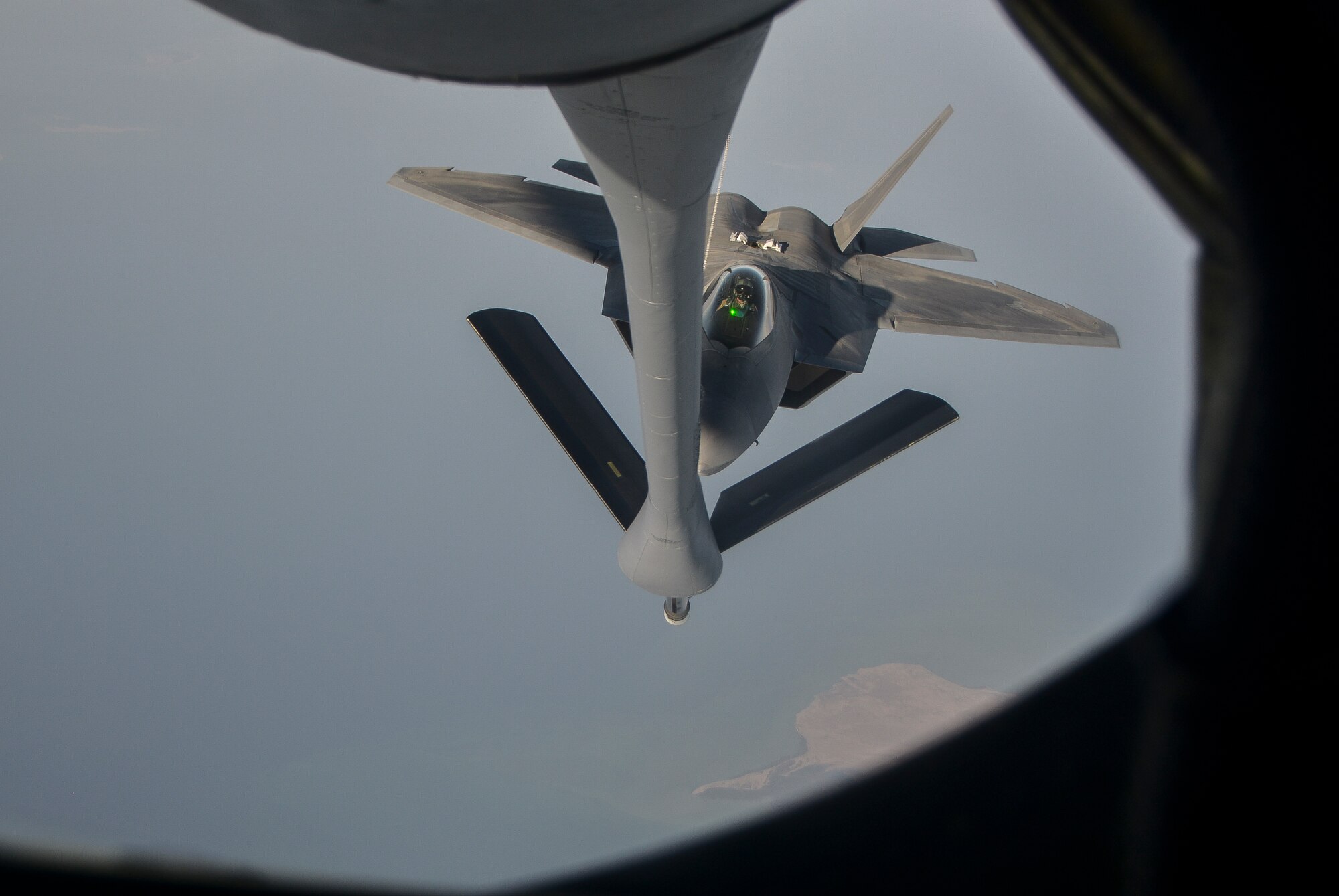 An F-22 Raptor lines up with the refueling boom of a KC-135 Stratotanker from the 340th Expeditionary Air Refueling Squadron at an undisclosed location in Southwest Asia, Feb. 26, 2014. Airmen from the 340th EARS at Al Udeid Air Base, Qatar, make up the U.S. Air Forces Central Command’s area of responsibility main refueling squadron which supports the aircraft of Operation Enduring Freedom. Aerial refueling extends the capabilities of any aircraft by expanding the range, limited only by crew fatigue and fuel consumption of the aircraft. (U.S. Air Force photo/Senior Airman Jared Trimarchi) 