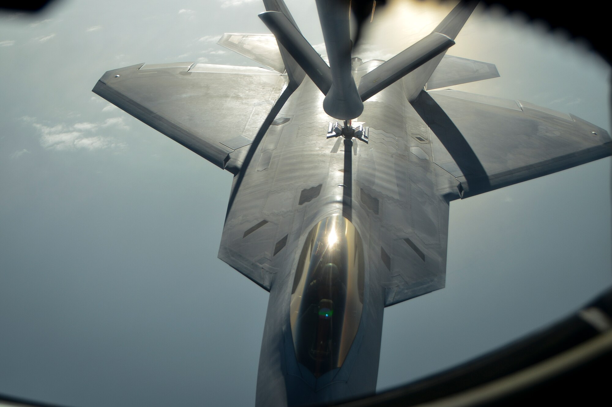 An F-22 Raptor is refueled by the boom of a KC-135 Stratotanker from the 340th Expeditionary Air Refueling Squadron at an undisclosed location in Southwest Asia, Feb. 26, 2014. Airmen from the 340th EARS at Al Udeid Air Base, Qatar, make up the U.S. Air Forces Central Command’s area of responsibility main refueling squadron which supports the aircraft of Operation Enduring Freedom. Aerial refueling extends the capabilities of any aircraft by expanding the range, limited only by crew fatigue and fuel consumption of the aircraft. (U.S. Air Force photo/Senior Airman Jared Trimarchi) 