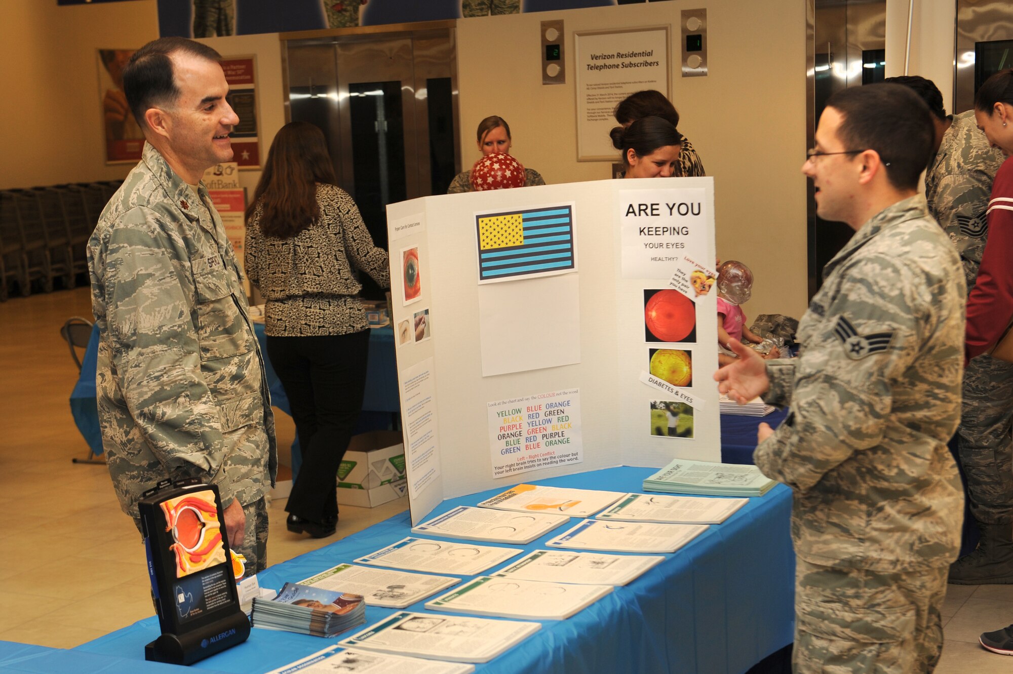 U.S. Air Force Maj. Anthony Spencer, 18th Medical Group optometrist, explains the importance of optical health to an Airman during the National Patient Safety Awareness Week health fair in The Exchange lobby on Kadena Air Base Japan, March 6, 2014. The Kadena Optometry clinic completed over 7,000 visits in addition to their contact lens services this year.  (U.S. Air Force photo by Airman 1st Class Zackary A. Henry)