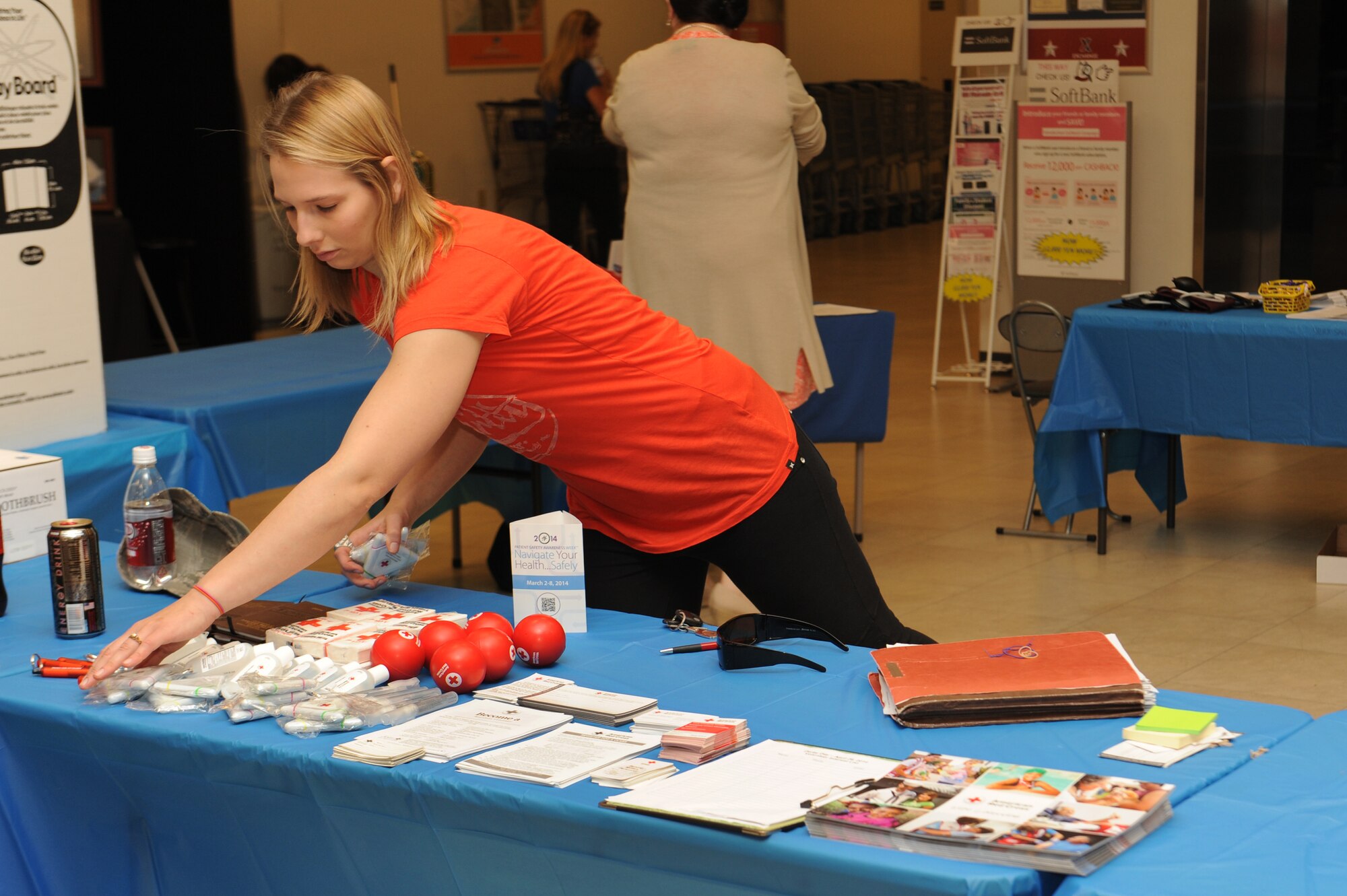 Constance Lund-Rowe, the new medical and dental volunteer program chairperson at the American Red Cross Kadena Station, finishes setting up a table for the National Patient Safety Awareness Week health fair at The Exchange on Kadena Air Base March 6. Her stand provided info on Red Cross medical programs. The 18th Medical Group is a proud partner of the National Patient Safety Foundation in a campaign to increase patient safety awareness within the healthcare organizations.  (U.S. Air Force photo by Airman 1st Class Zackary A. Henry)