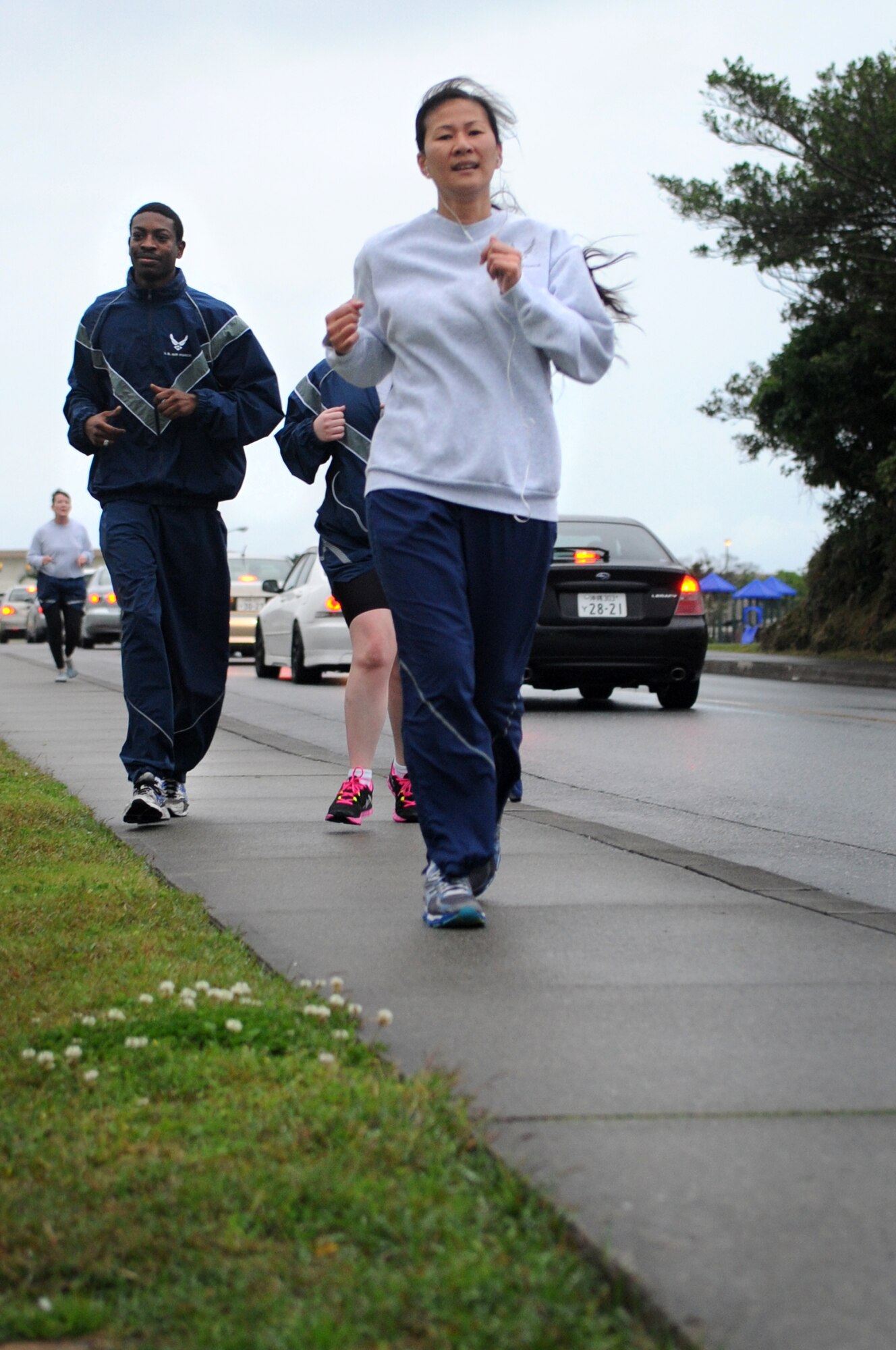 Members from the 18th Medical Group run during a 5k on Kadena Air Base, Japan, March 7, 2014. Team Kadena members participated in the run in support of National Patient Safety Awareness Week. The week serves as a reminder to patients that safe care can be established when they take an active role in the care process. (U.S. Air Force photo by Staff Sgt. Amber E. N. Jacobs)