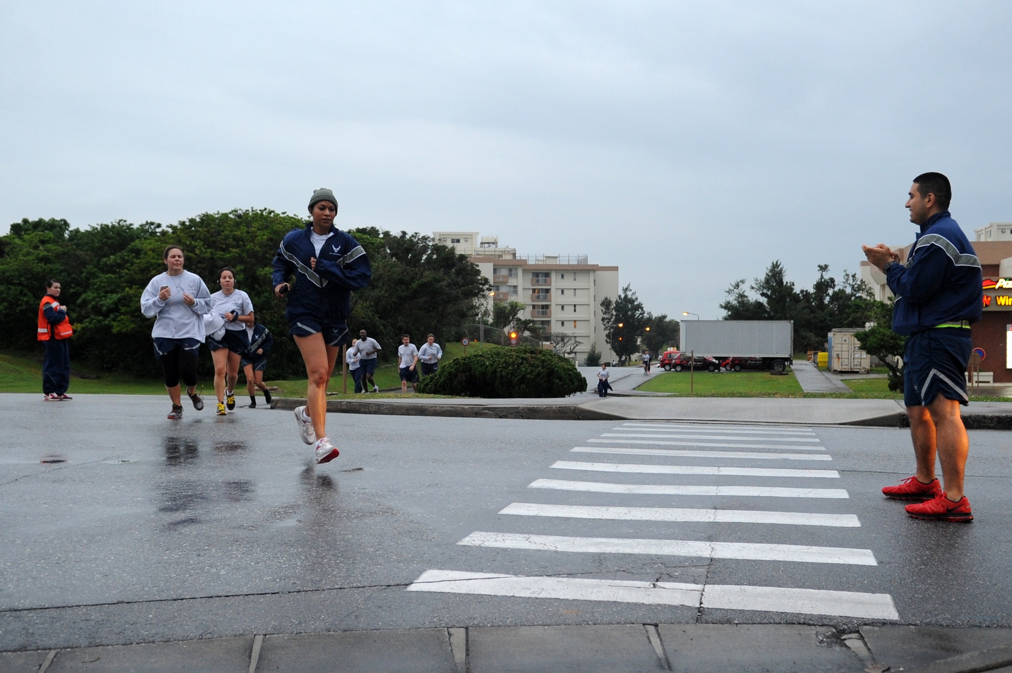 Members from the 18th Medical Group run during a 5k on Kadena Air Base, Japan, March 7, 2014. Team Kadena members participated in the run in support of National Patient Safety Awareness Week. Each year health care organizations from around the world take part in the event by creating awareness in their community and among their staff. (U.S. Air Force photo by Staff Sgt. Amber E. N. Jacobs