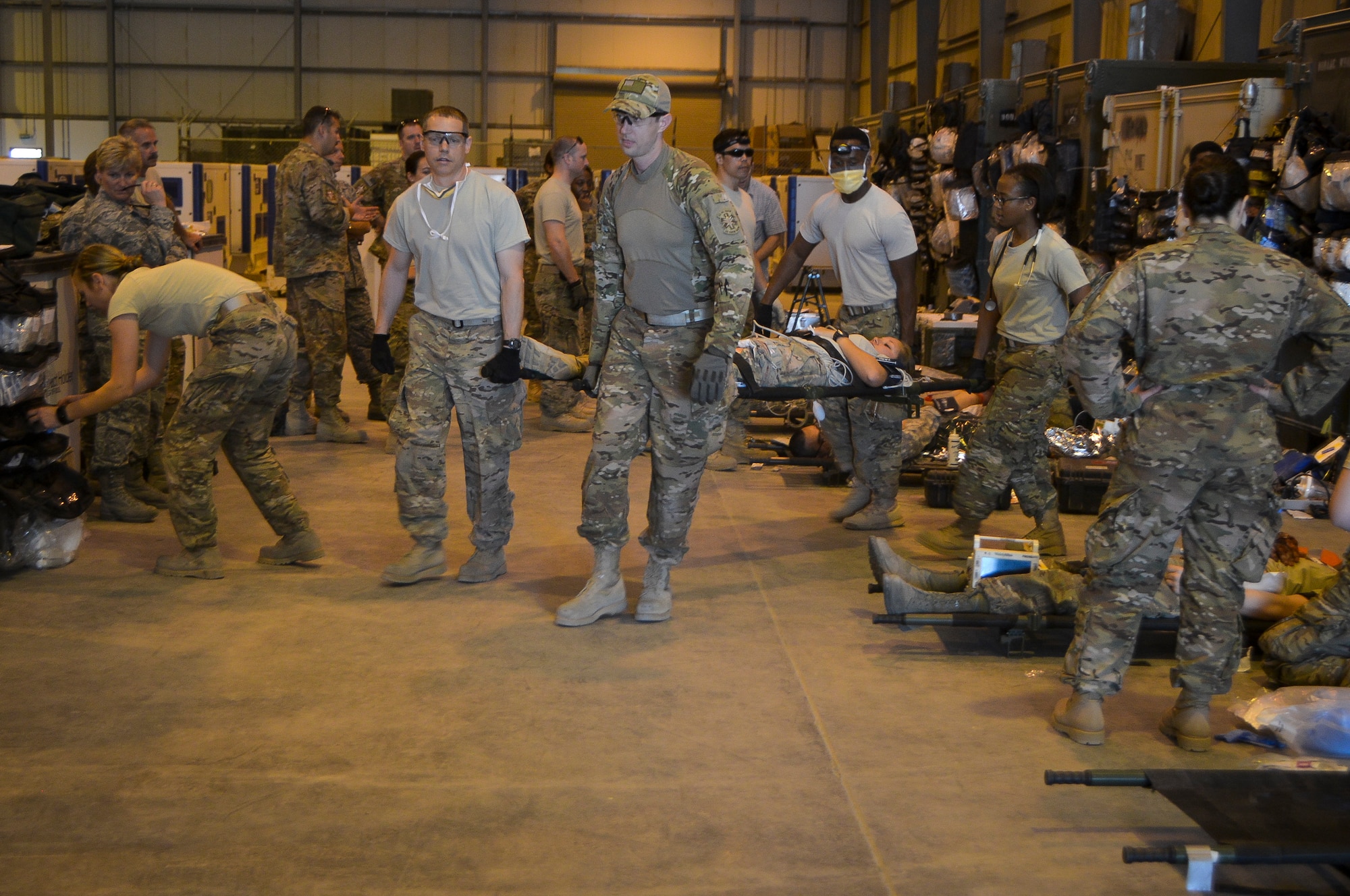 Airmen from the Mobile Field Surgical Team transport a simulated patient on a litter during a medical exercise at Al Udeid Air Base, Qatar, Feb. 27, 2014, to work on life-saving skills provided to wounded warriors. An MFST is a group of medical professionals who support forward operations throughout the U.S. Central Command's area of responsibility and Operation Enduring Freedom through advance trauma life support and critical care for service members wounded in combat. Mobile Field Surgical Teams act as a transition point to get patients to the next level of care and stabilize patients before they are able to be transported by air. (U.S. Air Force photo/Senior Airman Jared Trimarchi) 
