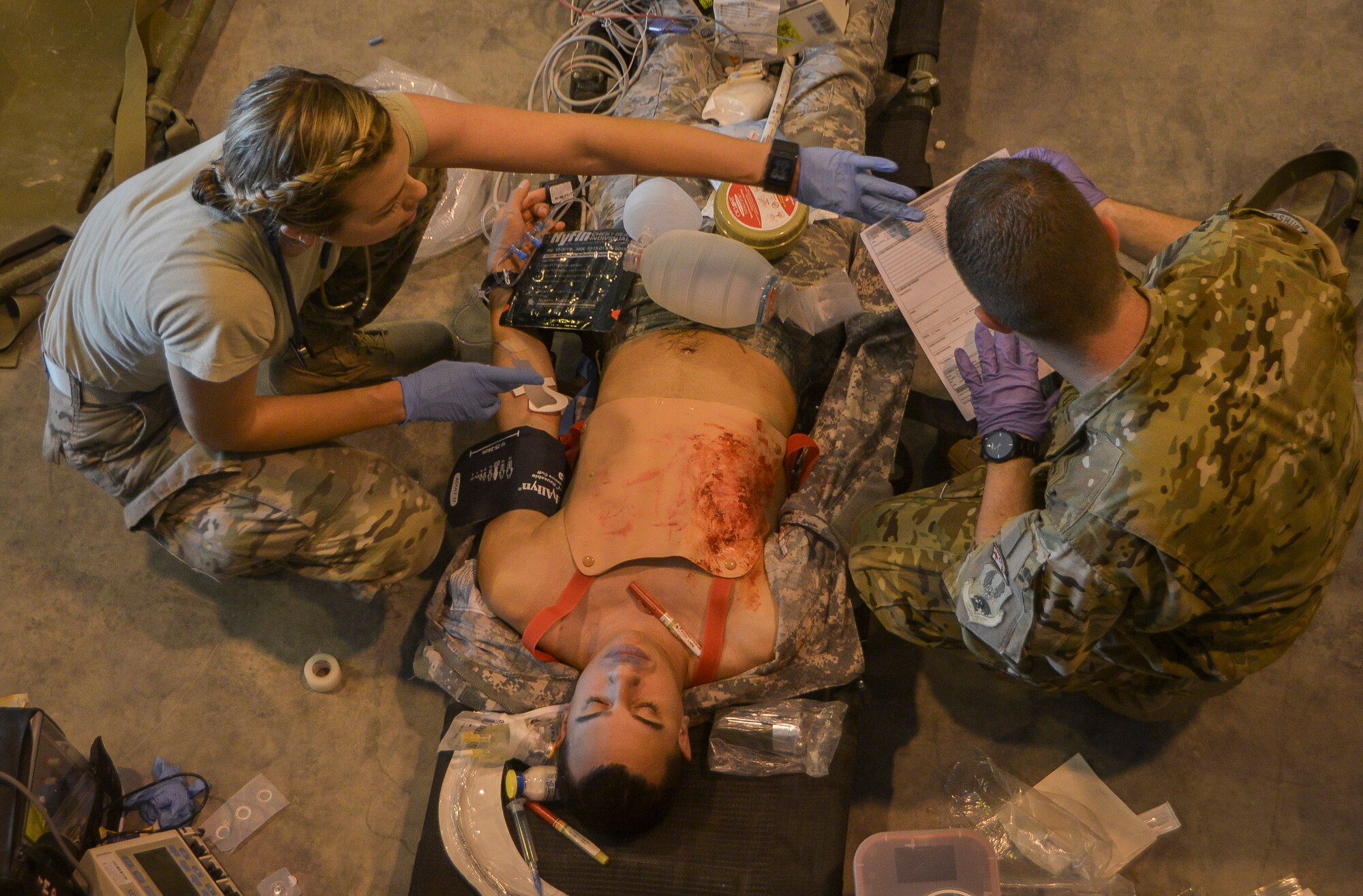 Capt. Laura Yaris, a member of the Mobile Field Surgical Team, works on stabilizing a simulated patient during a medical exercise at Al Udeid Air Base, Qatar, Feb. 27, 2014, to work on life-saving skills provided to wounded warriors. An MFST is a group of medical professionals who support forward operations throughout the U.S. Central Command's area of responsibility and Operation Enduring Freedom through advance trauma life support and critical care for service members wounded in combat. Mobile Field Surgical Teams act as a transition point to get patients to the next level of care and stabilize patients before they are able to be transported by air. Yaris is a critical care nurse deployed from Nellis Air Force Base, Nev., and a Saint Robert, Mo., native. (U.S. Air Force photo/Senior Airman Jared Trimarchi) 