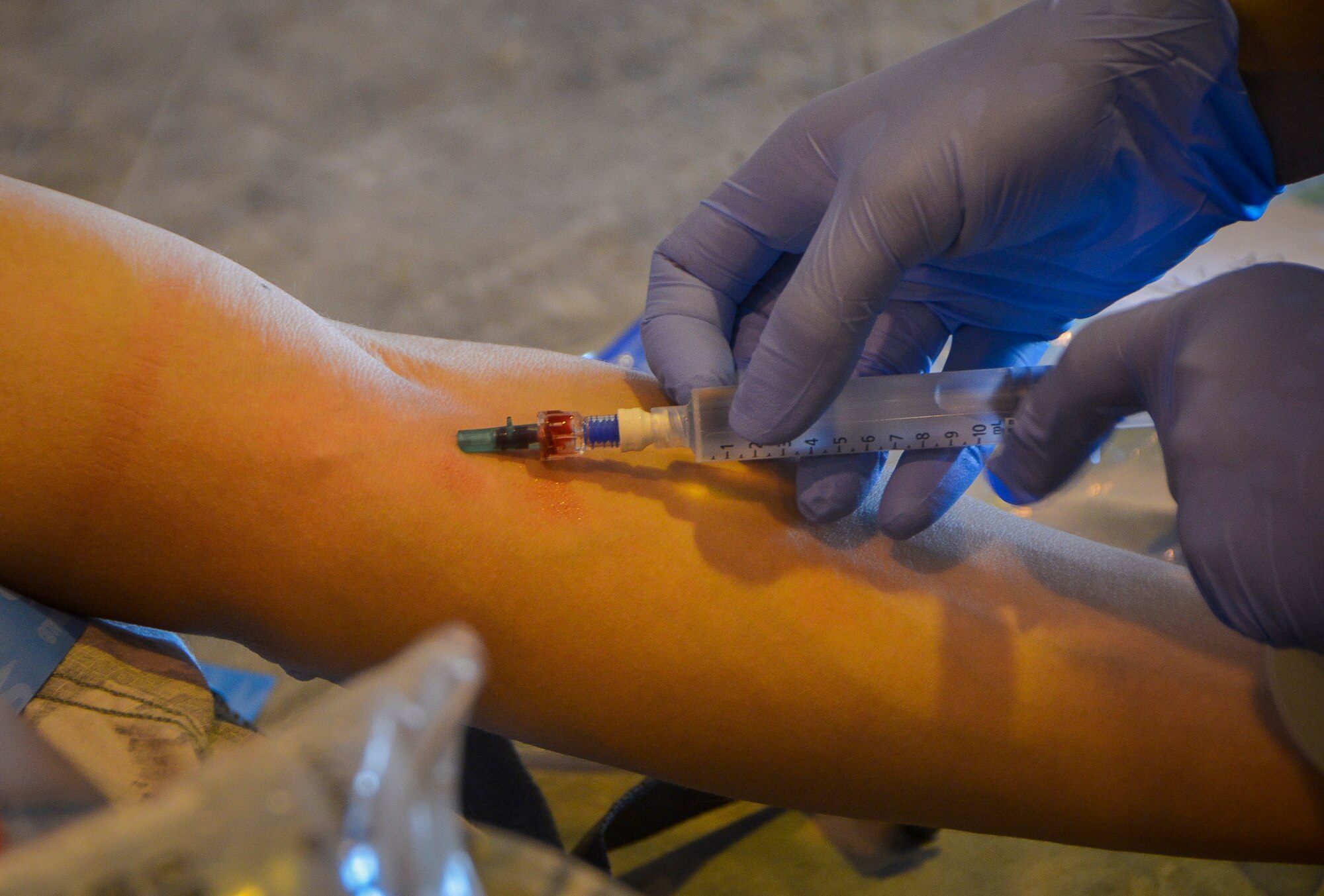 Capt. Laura Yaris, a member of the Mobile Field Surgical Team, starts an intravenous syringe on a simulated patient during a medical exercise at Al Udeid Air Base, Qatar, Feb. 27, 2014, to work on life-saving skills provided to wounded warriors. An MFST is a group of medical professionals who support forward operations throughout the U.S. Central Command's area of responsibility and Operation Enduring Freedom through advance trauma life support and critical care for service members wounded in combat. Mobile Field Surgical Teams act as a transition point to get patients to the next level of care and stabilize patients before they are able to be transported by air. Yaris is a critical care nurse deployed from Nellis Air Force Base, Nev., and a Saint Robert, Mo., native. (U.S. Air Force photo/Senior Airman Jared Trimarchi) 