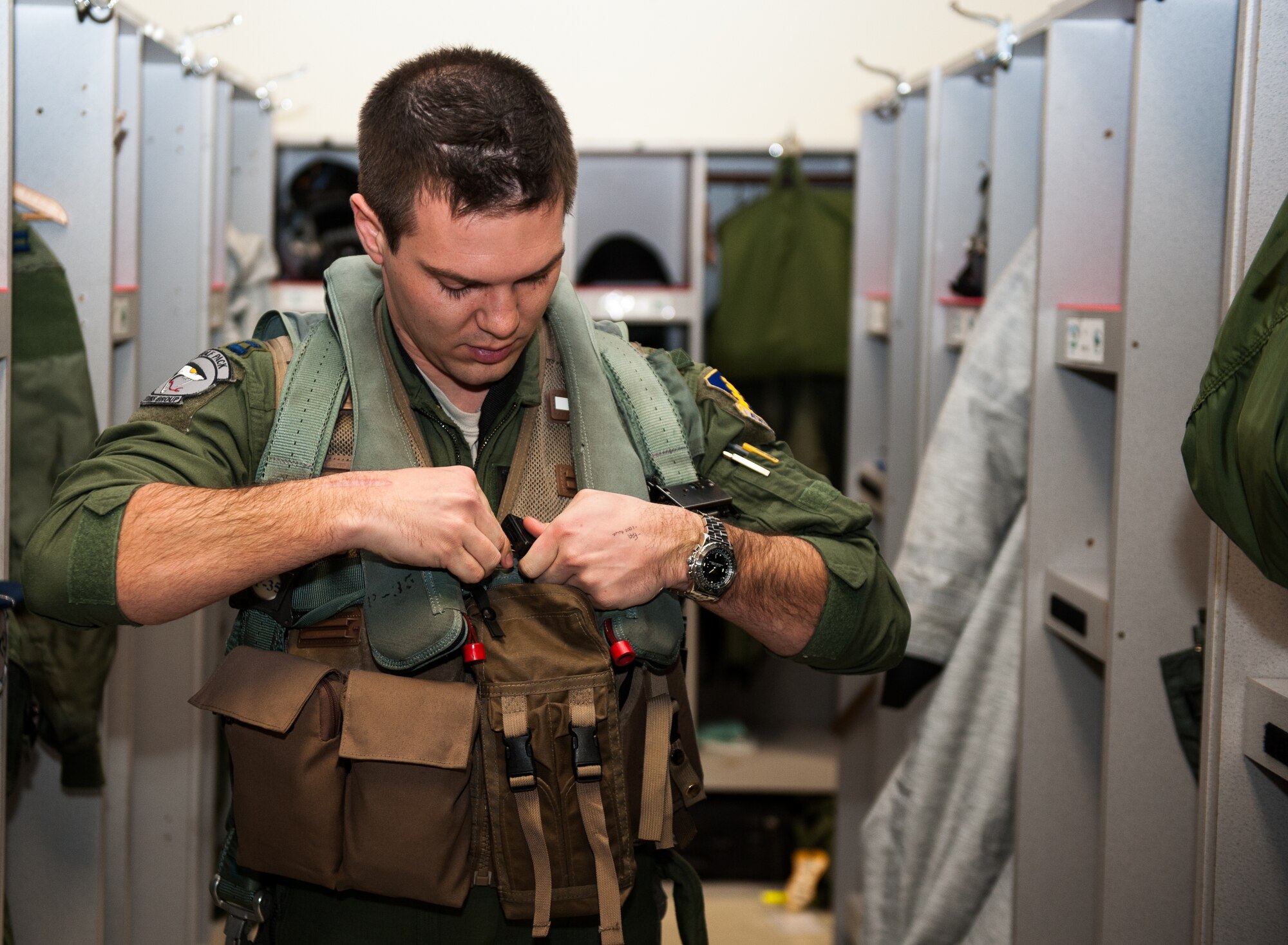 Capt. Mark Vahle, 8th Operations Group standardization and evaluation chief, prepares his flight gear at Kunsan Air Base, Republic of Korea, March 5, 2014. Vahle was one of two Wolf Pack pilots accepted into the Air Force’s test pilot school, where students are trained and tested on their ability to adapt and become an Air Force test pilot. (U.S. Air Force photo by Senior Airman Armando A. Schwier-Morales/Released)