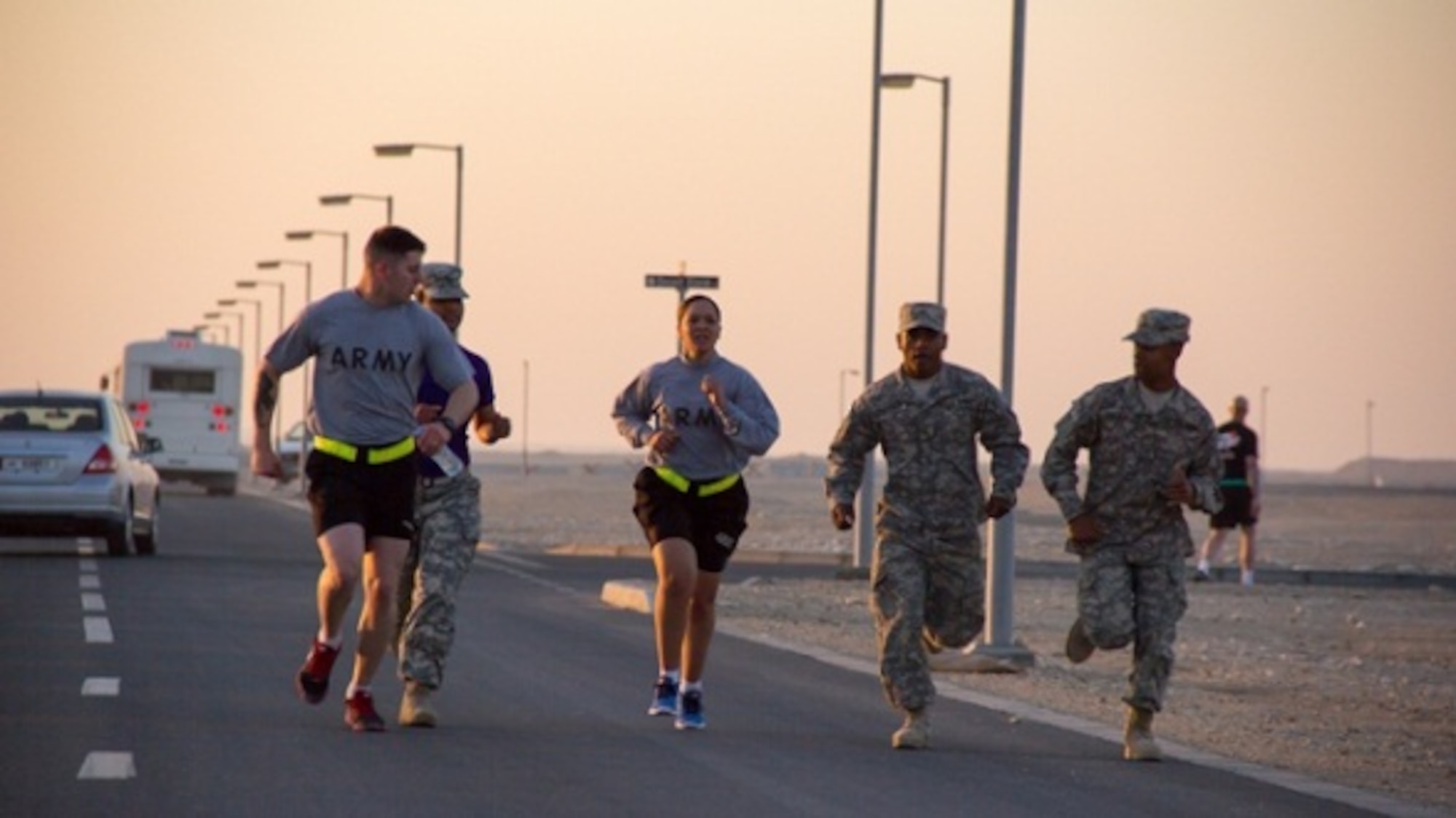 A 3-43 ADA Medic is cheered on by her fellow Soldiers as she completes the two-mile run as part of the U.S. Army Physical Training Test. (Courtesy photo) 