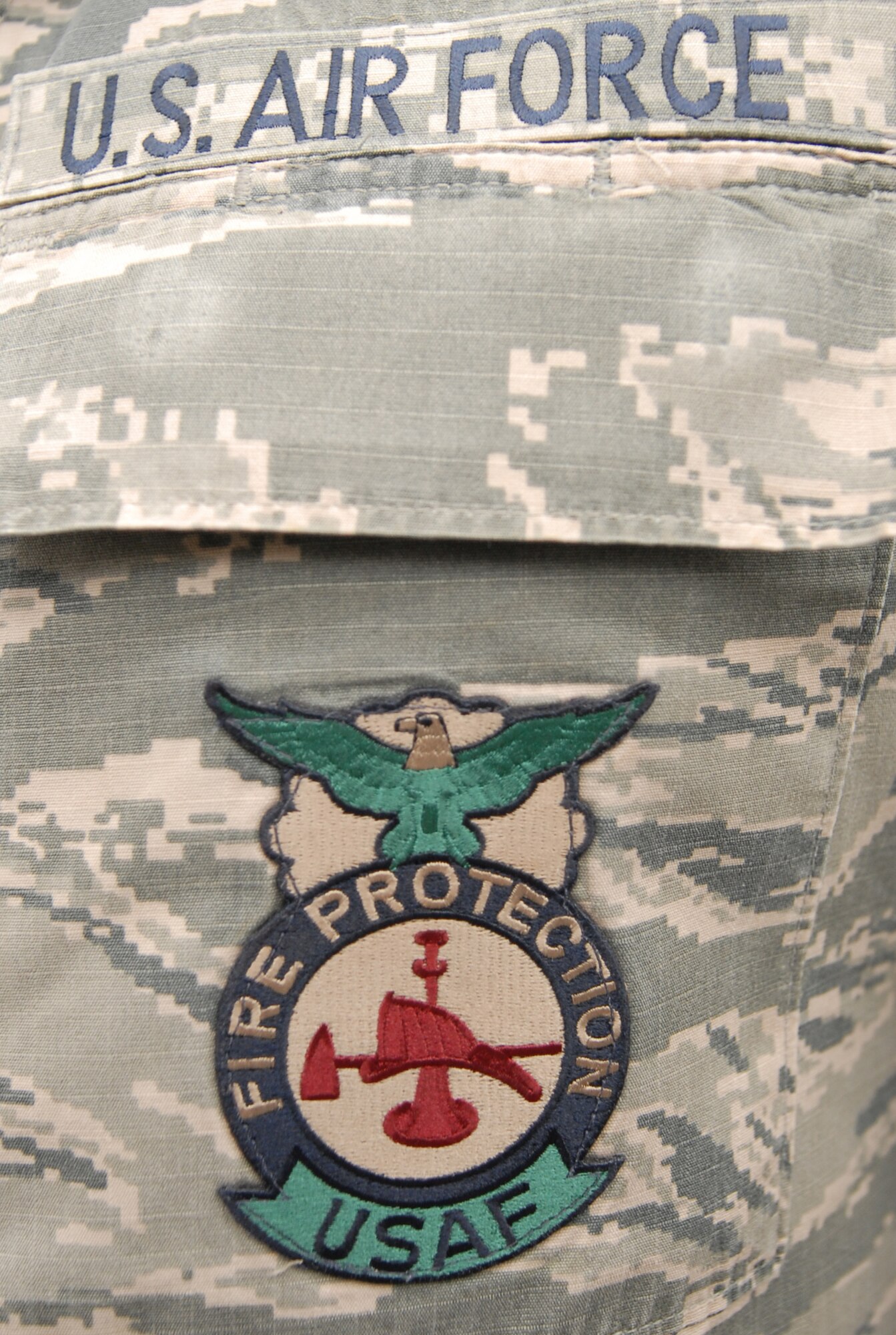 The Air Force fire protection badge is a mandatory item on the left breast pocket of the uniform for firefighters throughout the Air Force. The Kadena firefighters conducted training on March 6, 2014, on emergency maintenance, fire fighting tools, hazardous material decontamination, and explosive ordinance disposal for the participants in the Model Program. (U.S. Air Force photo by Airman 1st Class Stephen G. Eigel)