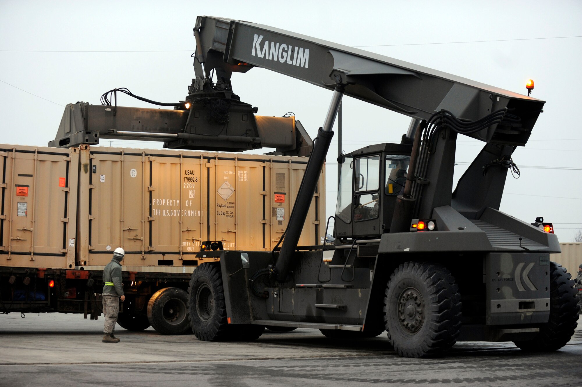 Airmen from both the 8th Maintenance Squadron and the 8th Logistics Readiness Squadron work to together to load crates of munitions onto tractor-trailers during a peninsula-wide munitions realignment at Kunsan Air Base, Republic of Korea, Feb. 26, 2014. The realignment efforts allow the 8th Fighter Wing to better meet operational requirements by decreasing periodic inspection requirements, munition container repairs and re-warehousing. (U.S. Air Force photo by Staff Sgt. Jessica Haas/Released)