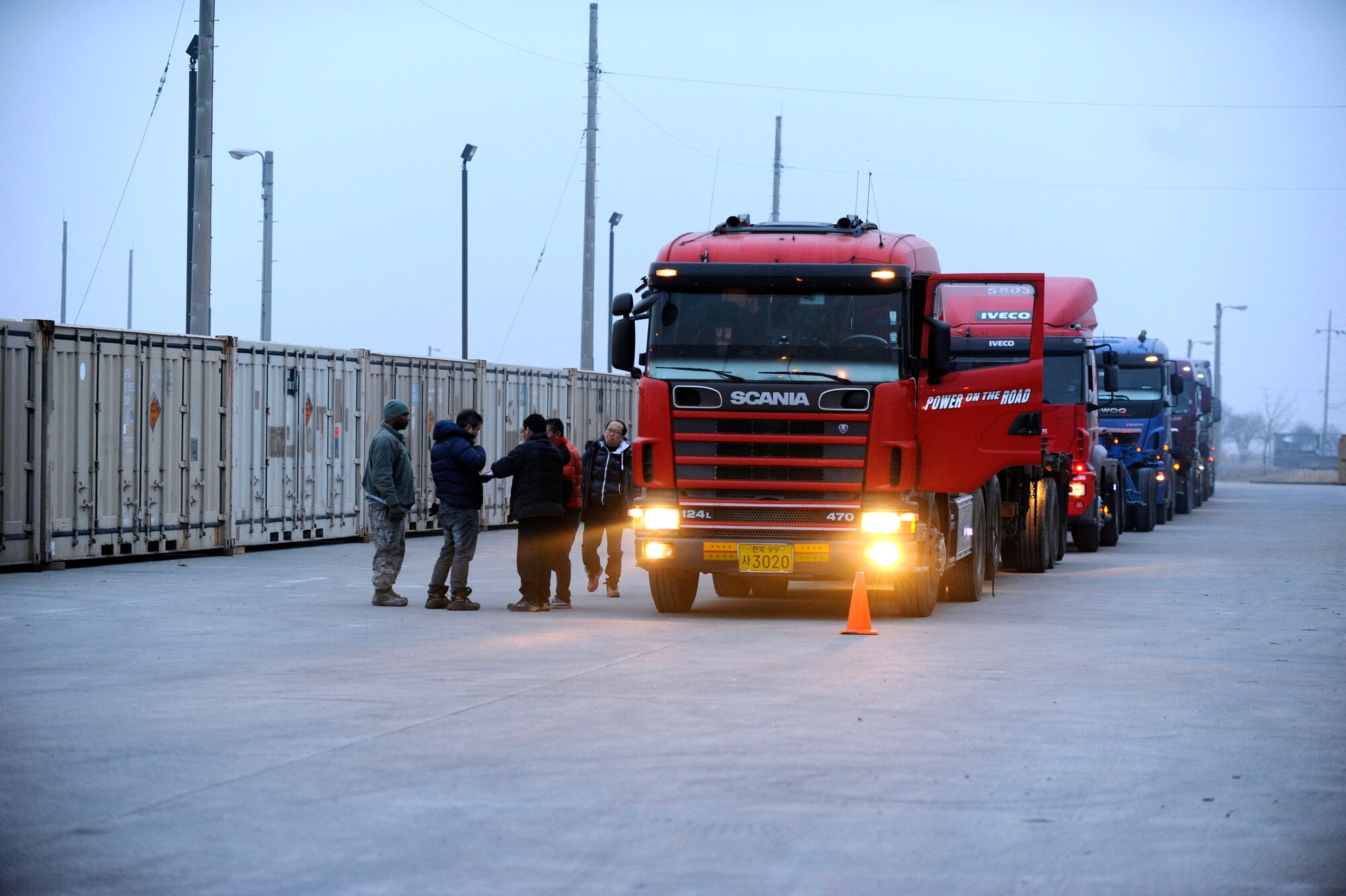 Tech. Sgt. Rashad Dudley, 8th Logistics Readiness Squadron outbound cargo noncommissioned officer-in-charge, inspects each tractor-trailer with drivers before it is loaded with crates of munitions during a large-scale munitions realignment at Kunsan Air Base, Republic of Korea, Feb. 26, 2014. The realignment efforts allow the 8th Fighter Wing to better meet operational requirements by decreasing periodic inspection requirements, munition container repairs and re-warehousing. (U.S. Air Force photo by Staff Sgt. Jessica Haas/Released)