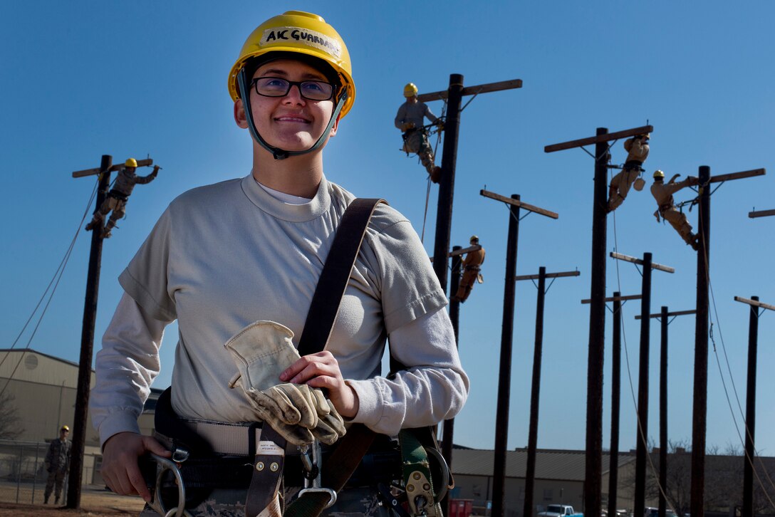 Air Force Airman 1st Class Tracy A. Guardado stands next to a training course for electrical systems apprentices Feb. 10, 2014, at Sheppard Air Force Base, Texas. U.S. Air Force photo by Mike Meares