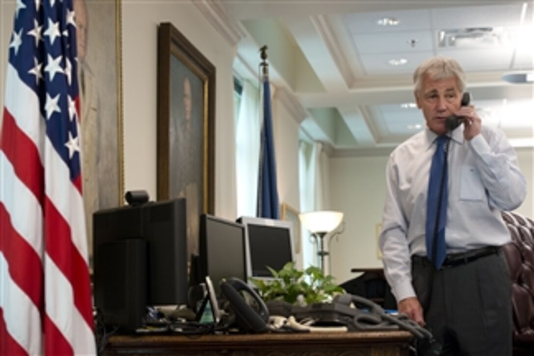 Defense Secretary Chuck Hagel speaks with Ihor Tenyukh, Ukraine's acting defense minister, over the phone while in his office at the Pentagon, March 7, 2014.