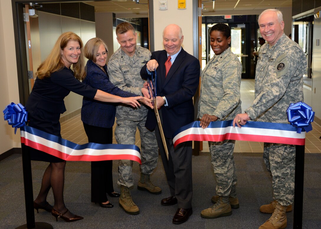 (L to R) Ms. Barbara Costello, Costello Construction representative, Mrs. Barbara Nemcheck, Project Manager for Burns & McDonnell, U.S. Air Force Brig. Gen. Scott Kelly, 175th Wing Commander, U.S. Sen. Benjamin Cardin, Maryland, U.S. Air Force Brig. Gen. Allyson Solomon, Assistant Adjutant General-Air and U.S. Army Maj. Gen. James Adkins, Adjutant General Maryland National Guard, cut the ribbon during a ceremony inside the new 175th Wing headquarters building, March 8, 2014, at Warfield Air National Guard Base, Baltimore, Md. The new facility is the home of the 175th Wing Leadership, Mission Support Group, Medical Group and other wing support functions. (U.S. Air National Guard photo by Tech. Sgt. Chris Schepers/RELEASED)