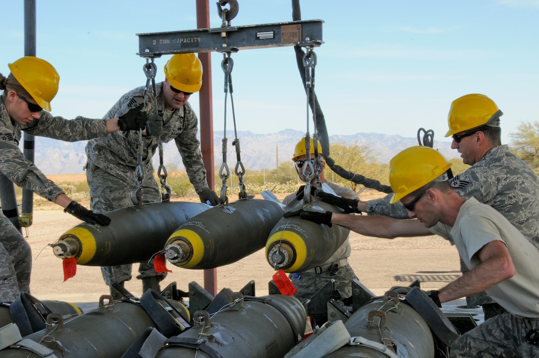 U.S. Air Force aircraft armament systems specialists from the New Jersey Air National Guard's 177th Fighter Wing transport Mark 82s onto a trailer on the munitions assembly conveyor pad at Davis-Monthan Air Force Base in Tucson, Ariz., Feb. 22, 2014. Airmen from the 177th assembled and loaded munitions for use at Operation Snowbird, a training facility for U.S. military flying units. (U.S. Air National Guard photo by Airman 1st Class Shane Karp/Released)