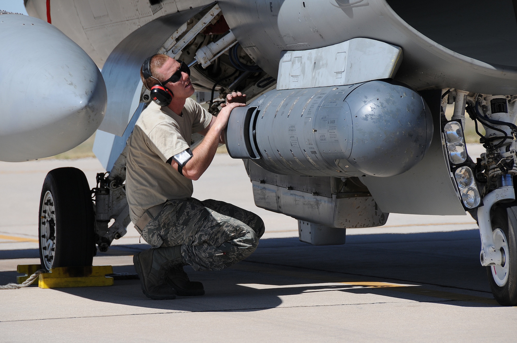 A picture of U.S. Air Force Senior Airman Mike Klinger, a crew chief with the 177th Fighter Wing, inspecting an aircraft.