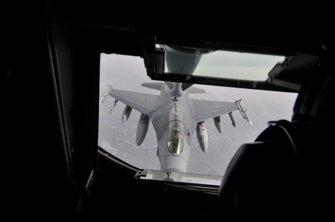A U.S. Air Force F-16D Fighting Falcon from the New Jersey Air National Guard's 177th Fighter Wing is refueled by Tech. Sgt. Santiago Avila, boom operator on a KC-135 Stratotanker from the Utah Air National Guard, en route to Operation Snowbird (OSB) training at Davis-Monthan Air Force Base, Ariz., on Feb. 19, 2014. Southern Arizona provides optimal weather conditions and ample ranges that mirror the environment found downrange, and OSB hosts an average of 10-12 units per year with two to 12 aircraft per visit for an average of two weeks. (U.S. Air National Guard photo by Master Sgt. Andrew Moseley/Released)