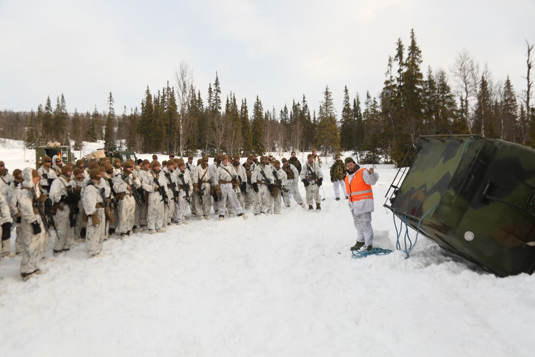 U.S. Marines with Company G, 2nd Battalion, 2nd Marine Regiment, 2nd Marine Division learn how to recover a Bandvagn 206 that has gotten stuck in the snow. Marines and Norwegian soldiers spent three days learning to work together and how to operate in the Norwegian winter environment to prepare the Marines and soldiers for Exercise Cold Response, which is a multinational and multilateral training exercise. The exercise will feature various types of military training including maritime, land and air operations. The location, above the Arctic Circle in northern Norway, provides a unique cold-weather environment for all forces involved to learn and develop procedures from one another.