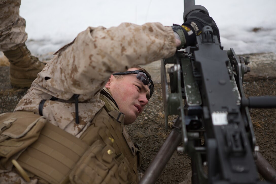U.S. Marine Cpl. Kahl Harmon, an Alta Loma, Calif, native and acting platoon sergeant with Weapons Company, 2nd Battalion, 2nd Marine Regiment, 2nd Marine Division inspects a .50 caliber machine gun prior to a live fire range March 6, 2014. Marines and Norwegian soldiers spent the day learning each other's weapons systems and training together prior to exercise Cold Response 2014, which is a multinational and multilateral training exercise. The exercise will feature various types of military training including maritime, land and air operations. The location, above the Arctic Circle in northern Norway, provides a unique cold-weather environment for all forces involved to learn and develop procedures from one another.