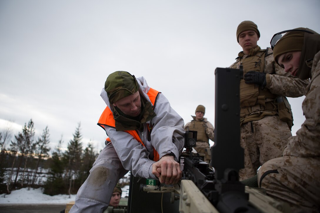 U.S. Marines with Company G, 2nd Battalion, 2nd Marine Regiment, 2nd Marine Division and Norwegian soldiers learn about each other's .50 caliber machine guns prior to a live-fire range March 6, 2014. The Marines and Norwegian soldiers spent the day learning each other's weapons systems and training together prior to exercise Cold Response 2014, which is a multinational and multilateral training exercise. The exercise will feature various types of military training including maritime, land and air operations. The location, above the Arctic Circle in northern Norway, provides a unique cold-weather environment for all forces involved to learn and develop procedures from one another.