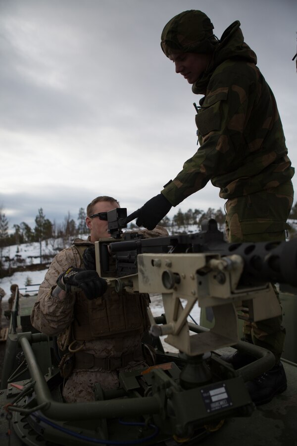 U.S. Marines with Company G, 2nd Battalion, 2nd Marine Regiment, 2nd Marine Regiment, 2nd Marine Division and Norwegian soldiers learn about each other’s .50 caliber machine guns prior to a live fire range March 6, 2014. The Marines and Norwegian soldiers spent the day learning each other’s weapons systems and training together prior to exercise Cold Response 2014, which is a multinational and multilateral training exercise. The exercise will feature various types of military training including maritime, land and air operations. The location, above the Arctic Circle in northern Norway, provides a unique cold-weather environment for all forces involved to learn and develop procedures from one another.