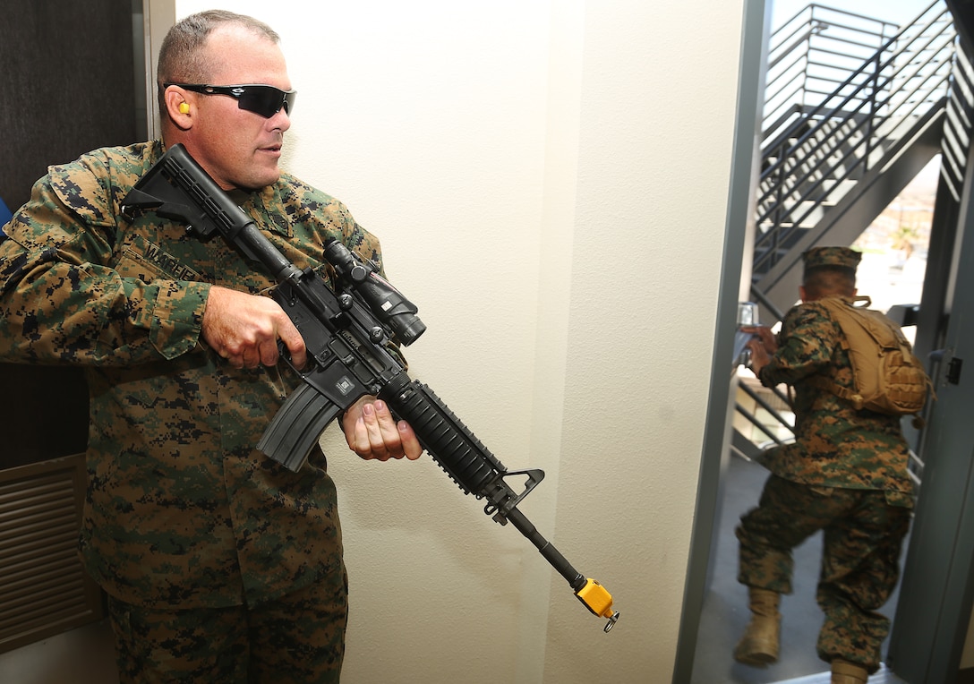 Gunnery Sgt. Robert Warfield, the active shooter in a scenario, traverses through the Education Center and shooting fellow role-players with blank rounds during an active-shooter exercise Feb. 25, 2014. More than 120 people participated in the exercise as the shooter went through the building with 40 blank rounds.


