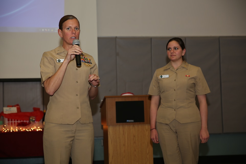 Cmdr. Wendy Stone, public health nurse, Robert E. Bush Naval Hospital and Lt. j. g. Rachel Smith, dietician, RBNH, lecture women on the topic of proper nutrition during a Red Dress Gala event at the community center, Feb. 27, 2014. Discussions on health were made to educate women on lowering their risk of heart disease.