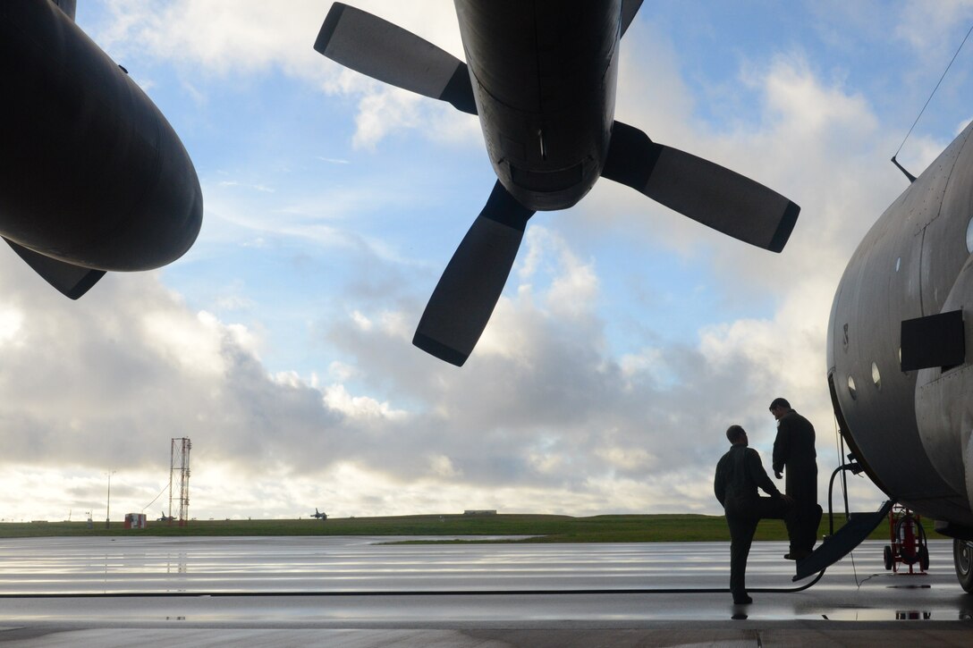 Tech. Sgt. Dusty Surber, 36th Airlift Squadron flight engineer, speaks with Capt. Joseph Goetz, 36th AS flight commander, prior to boarding a C-130 Hercules Feb. 20, 2014, on Andersen Air Force Base, Guam, for humanitarian assistance and disaster relief training during Exercise Cope North 2014. Cope North is a multilateral aerial and humanitarian assistance and disaster relief exercise, held annually, designed to increase the combat readiness and interoperability of the U.S. Air Force, U.S. Navy, Japan Air Self-Defense Force, Royal Australian Air Force and Republic of Korea Air Forces. (U.S. Air Force photo by Airman 1st Class Emily A. Bradley/Released)