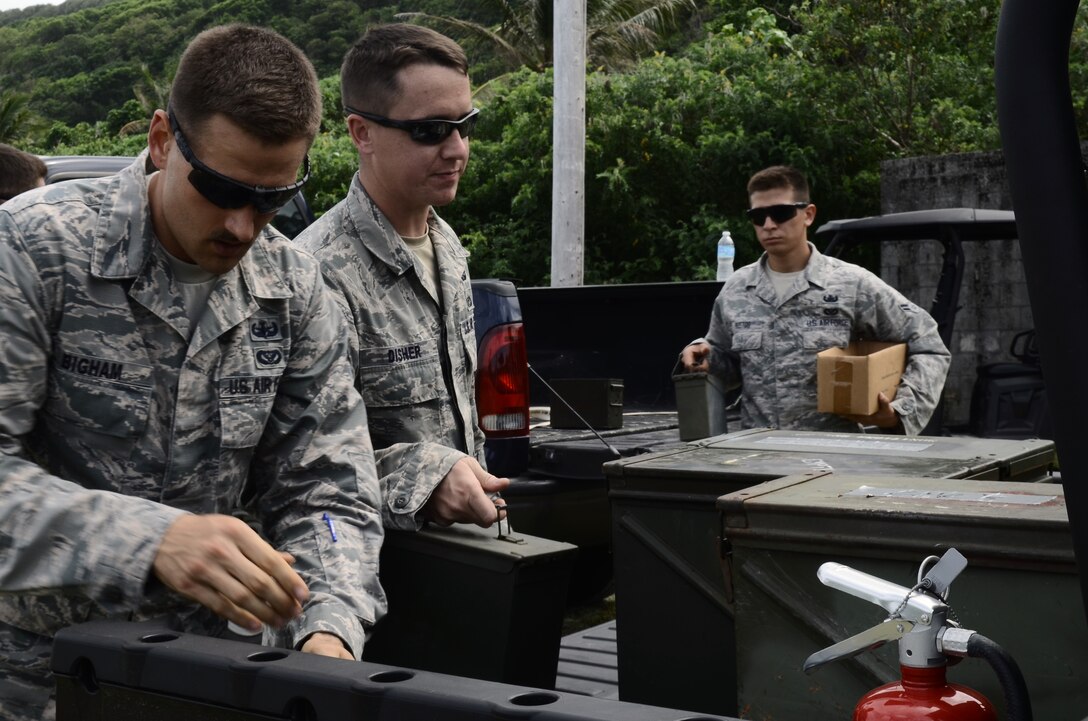 Airmen from the 36th Civil Engineer Squadron Explosive Ordnance Disposal Flight load explosives onto a utility vehicle before a demolition demonstration for Japan Air Self-Defense Force 83rd Air Wing members Feb. 21, 2014, on Andersen Air Force Base, Guam. The JASDF Airmen were here as part of Exercise Cope North 2014, a multilateral training event designed to improve the mission readiness and combined interoperability of the U.S. Air Force, JASDF, and the Royal Australian Air Force. (U.S. Air Force photo by Airman 1st Class Amanda Morris/Released)