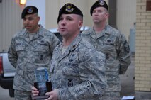 Maj. William Dains II, commander of the 433rd Security Forces Squadron, addresses the unit, March 8, 2014, during morning formation. He congratulated them on winning the Air Force Reserve Command’s 2013 Outstanding Security Forces Tenant Unit of the Year. In the 66 year history of the wing, the Security Forces have never won this award until this year. (U.S. Air Force photo by Tech Sgt. Carlos J. Trevino)
