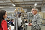 Angelica White, an employer from United Services Automobile Association, San Antonio, and Todd Reddic from U.S. Army Medical Department Center, Joint Base San Antonio-Fort Sam Houston, listens to Col. Aaron Vangelisti, 433rd Airlift Wing commander, Joint Base San Antonio-Lackland as they visit the Cargo Load Training Facility. Civilian employers saw what their employees do when they put on the military uniform on a Unit Training Assembly weekend. (U.S. Photo by Tech Sgt. Carlos Trevino)