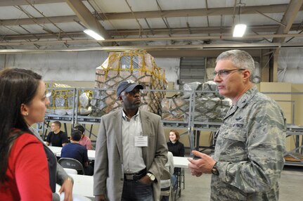 Angelica White, an employer from United Services Automobile Association, San Antonio, and Todd Reddic from U.S. Army Medical Department Center, Joint Base San Antonio-Fort Sam Houston, listens to Col. Aaron Vangelisti, 433rd Airlift Wing commander, Joint Base San Antonio-Lackland as they visit the Cargo Load Training Facility. Civilian employers saw what their employees do when they put on the military uniform on a Unit Training Assembly weekend. (U.S. Photo by Tech Sgt. Carlos Trevino)