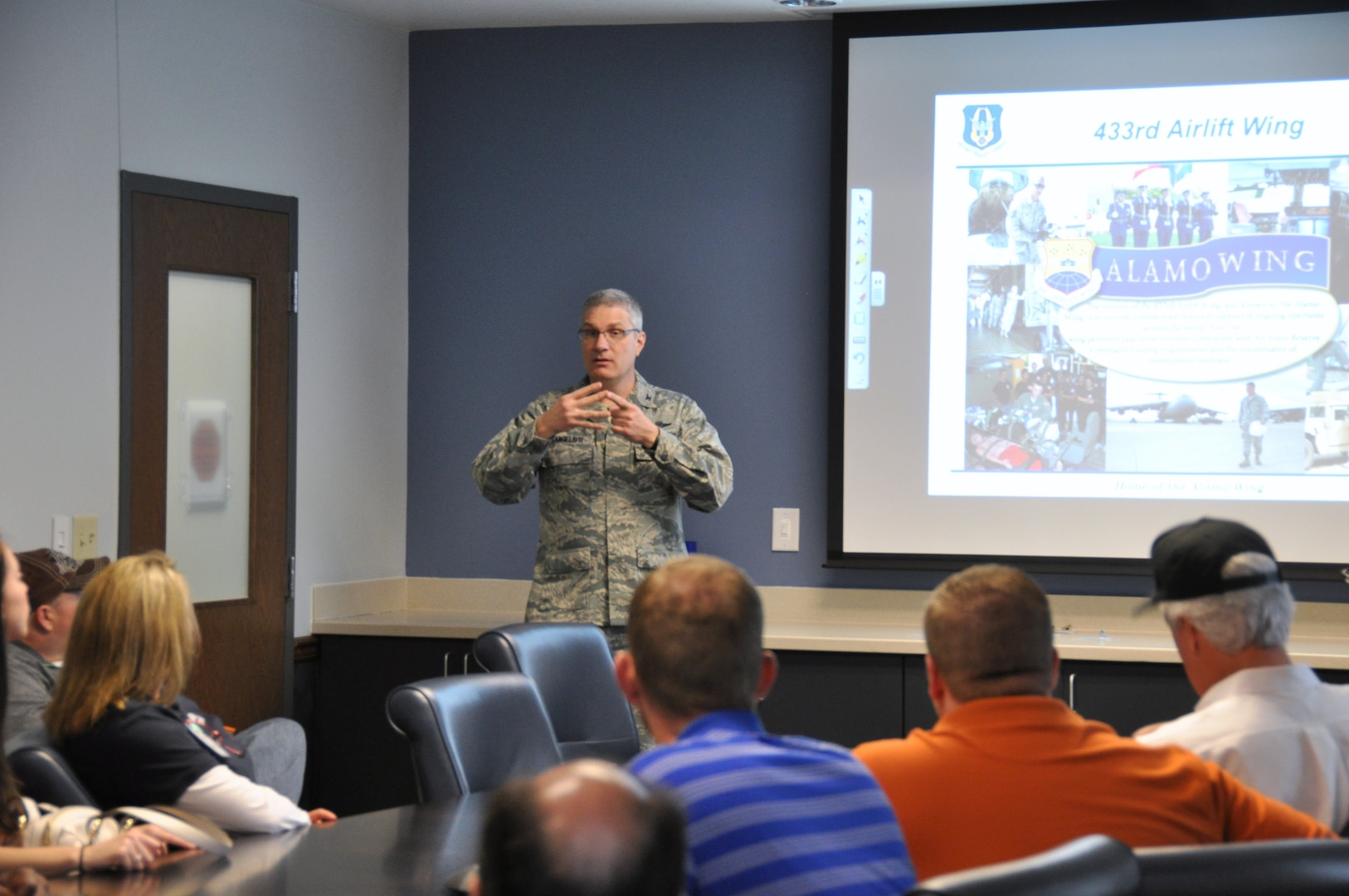 Col. Aaron Vangelisti, 433 Airlift Wing commander, Joint Base San Antonio-Lackland gives a mission briefing to civilian employers, March 8, 2014 at the 433rd headquarters building. The 433rd Airlift Wing hosts Employer Orientation Day annually to help civilian employers understand the requirements of their employee’s military Reserve duty. (U.S. Air Force photo by Tech Sgt. Carlos J. Trevino)