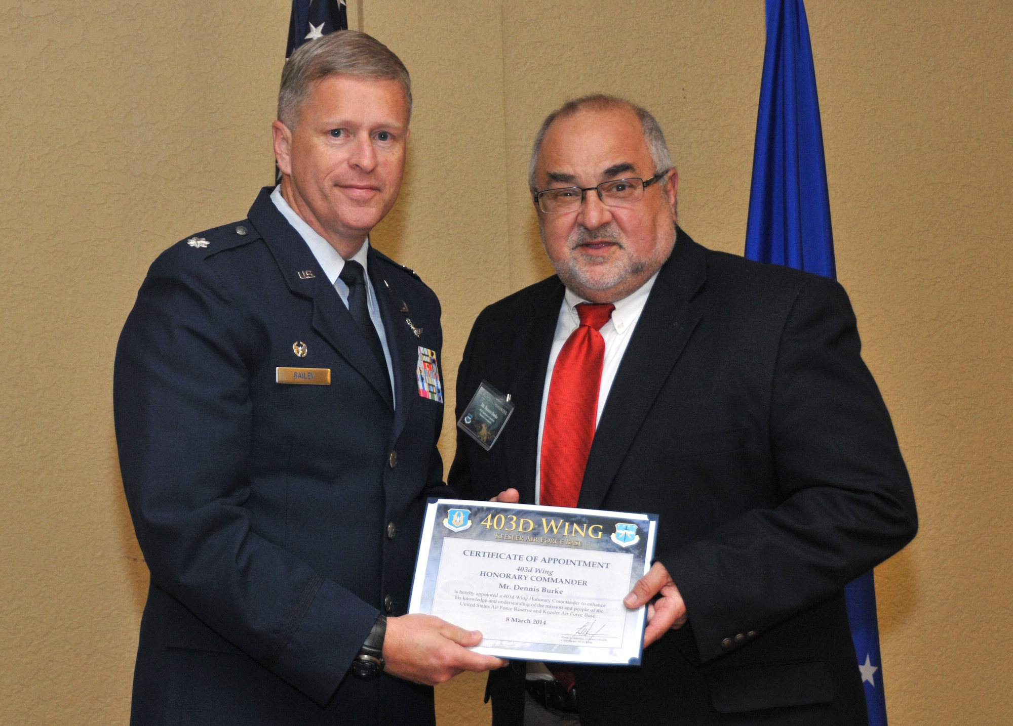 Lt. Col. Kelley L. Bailey, 403rd Maintenance Squadron commander, inducts Dennis Burke, vice president, Business Development, The People’s Bank, into the 403rd Wing Honorary Commander Program March 8, 2014.The program provides Gulf Coast community and corporate leaders the chance to learn more about Air Force personnel, programs and operations, but also affords military commanders and members an opportunity to learn more about the people and the inner workings of their local community. (U.S. Air Force photo/Tech. Sgt. Ryan Labadens)
