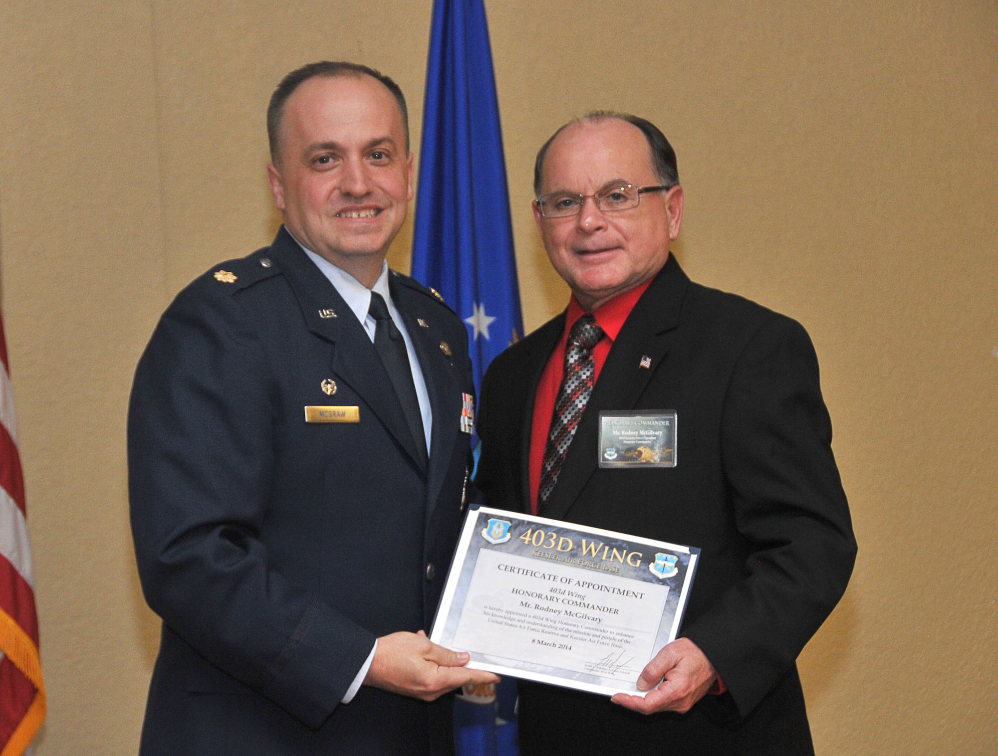 Maj. Sean P. McGraw, 403rd Security Forces Squadron commander, inducts Rodney McGilvary, deputy chief, Biloxi Police Department, into the 403rd Wing Honorary Commander Program March 8, 2014.The program provides Gulf Coast community and corporate leaders the chance to learn more about Air Force personnel, programs and operations, but also affords military commanders and members an opportunity to learn more about the people and the inner workings of their local community. (U.S. Air Force photo/Tech. Sgt. Ryan Labadens)