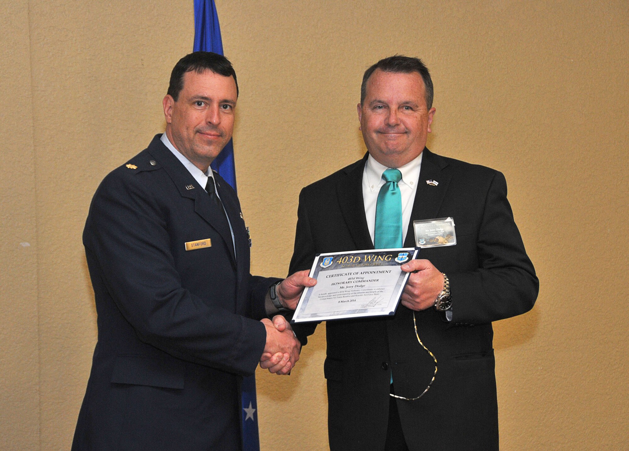 Maj. David B. Stanford, 403rd Civil Engineer Squadron commander, inducts Jerry Dodge, regional manager for The People’s Bank, into the 403rd Wing Honorary Commander Program March 8, 2014.The program provides Gulf Coast community and corporate leaders the chance to learn more about Air Force personnel, programs and operations, but also affords military commanders and members an opportunity to learn more about the people and the inner workings of their local community. (U.S. Air Force photo/Tech. Sgt. Ryan Labadens)